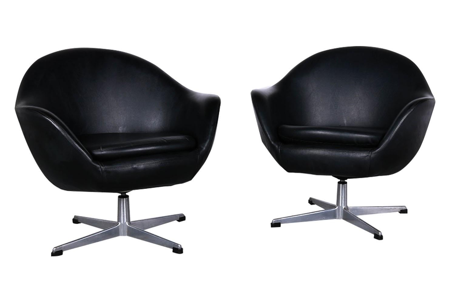 A beautiful pair of Mid-Century Black Overman Swedish, vintage, swivel, pod, lounge chairs designed by Swedish designer Carl Eric Klote for Overman Denmark in the 1960’s. The pair is comfortable and remarkably high quality, with gorgeous, chromed