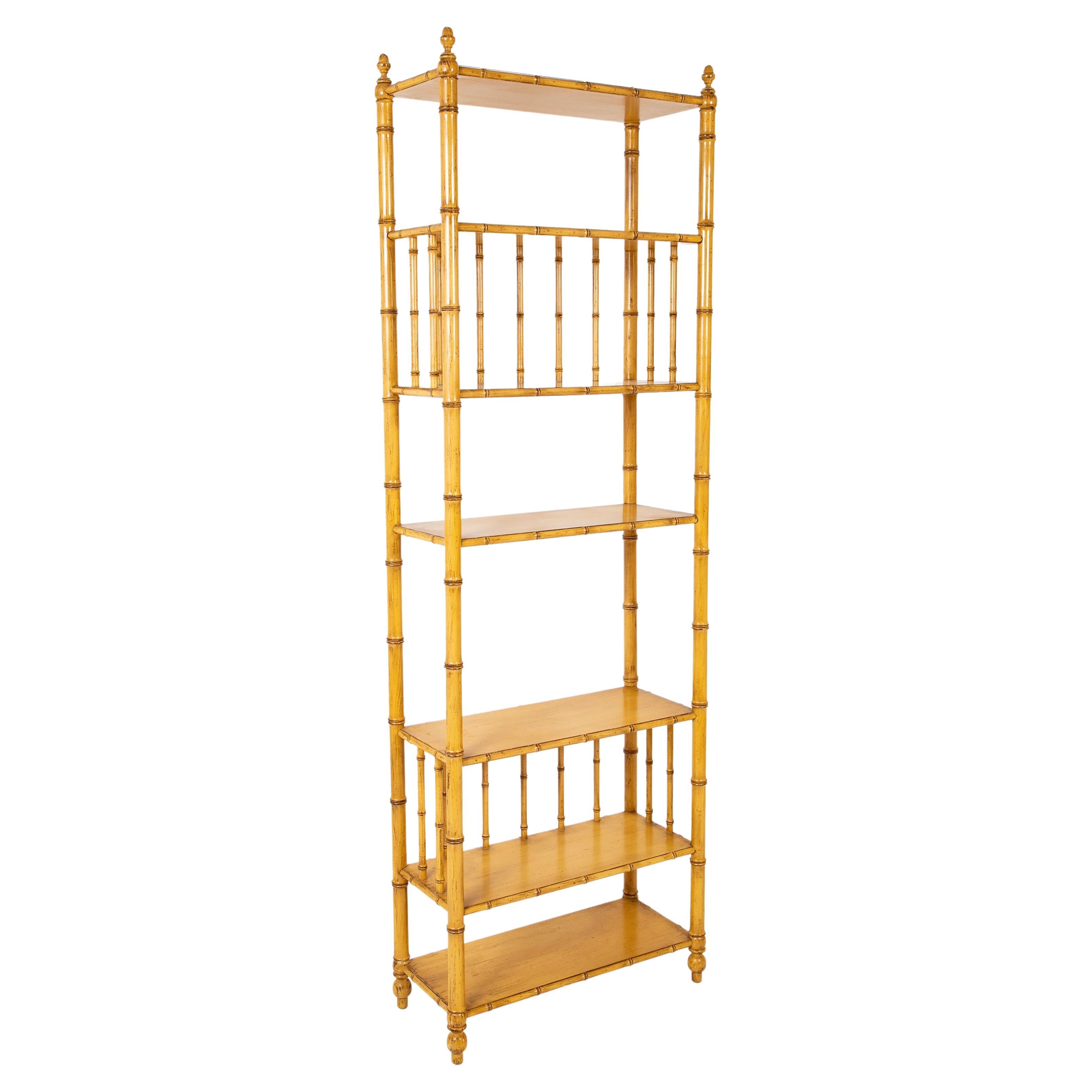 Great pair of faux bamboo tall shelves beautifully painted in a pale yellow finish. Each with six shelves of varying heights, they make wonderful displays for your cherished collections and books. Very rare to find a pair of these mid 20th century