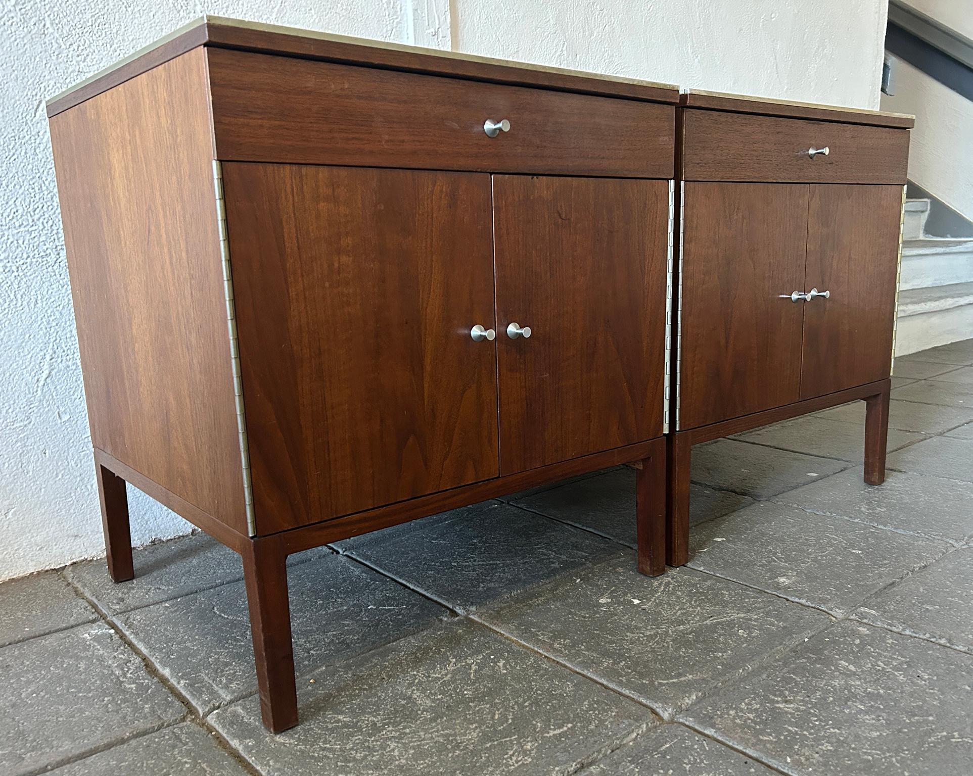 Beautiful pair of Paul McCobb circa 1960 #7700 walnut nightstands end tables with tan leather lined drawers and Aluminum trim. Has single-drawer with lower cabinet that has 1 adjustable shelf. Solid Aluminum top trim, hinges and knobs - original