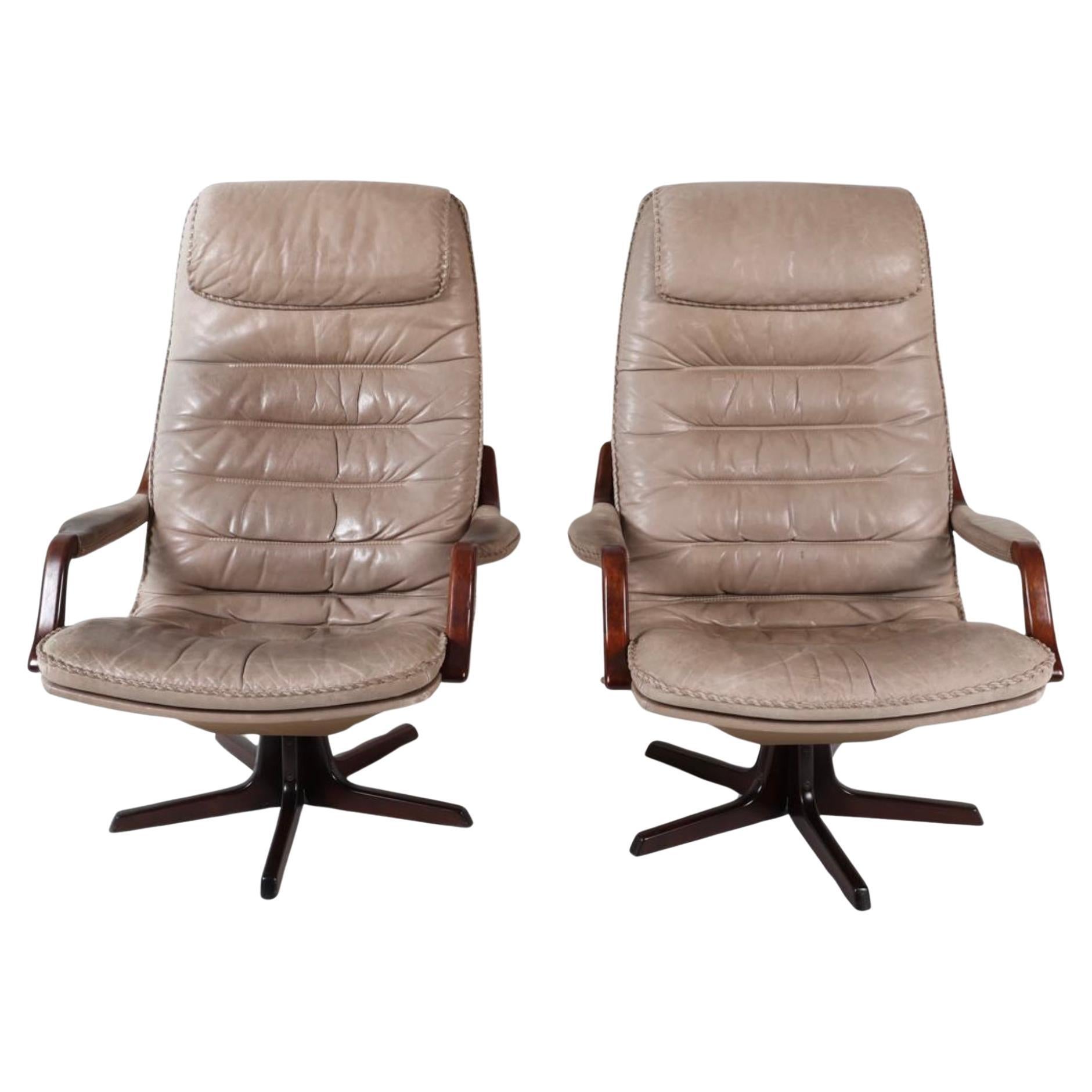 Pair Mid Century Scandinavian modern Tan High back Leather Swivel Lounge chairs