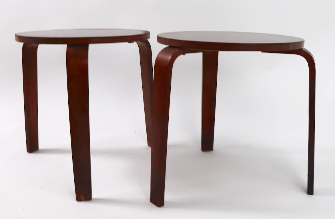 Midcentury architectural stacking side, end tables attributed to Thonet. Each table has a round formica laminate top, on three bentwood legs. Both are in good vintage condition, one shows minor loss to finish at base of legs, as shown. Structurally
