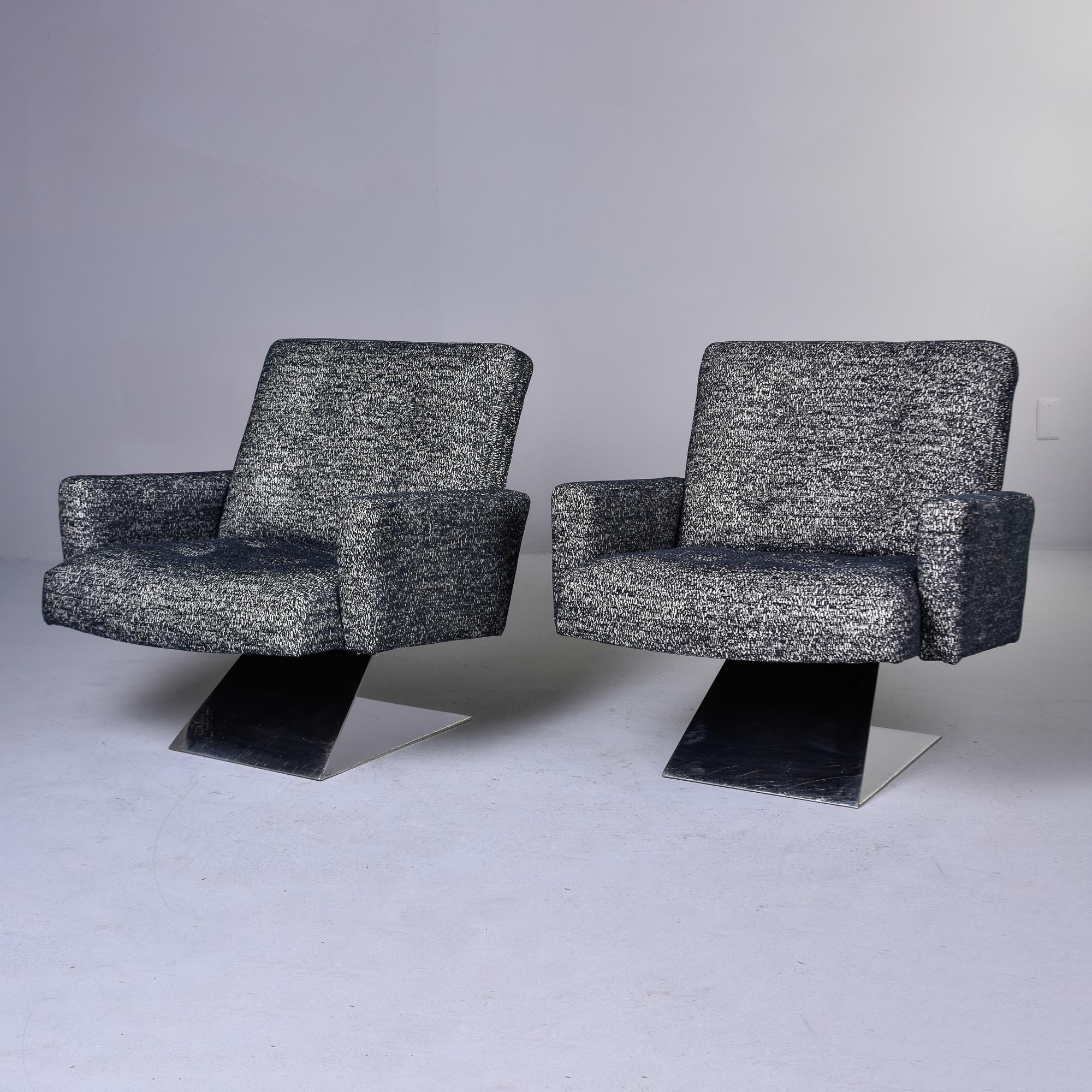 Found in the US, this pair of chairs date from the 1980s. Heavy, polished steel Z-form base with upholstered armchairs. Newly upholstered in a black and off-white woven fabric. Seat backs have four buttons. Unknown maker. 

Arm Height:  22”     