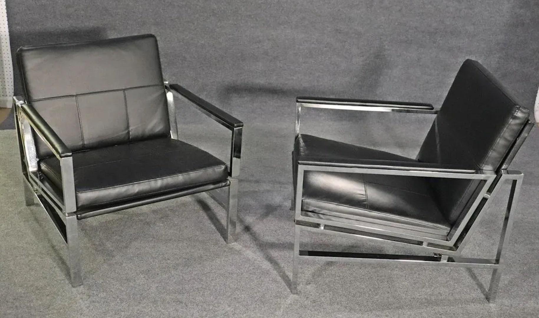 Mid-Century Modern style arm chairs with flat bar chrome frames and leather seats.
Please confirm location.