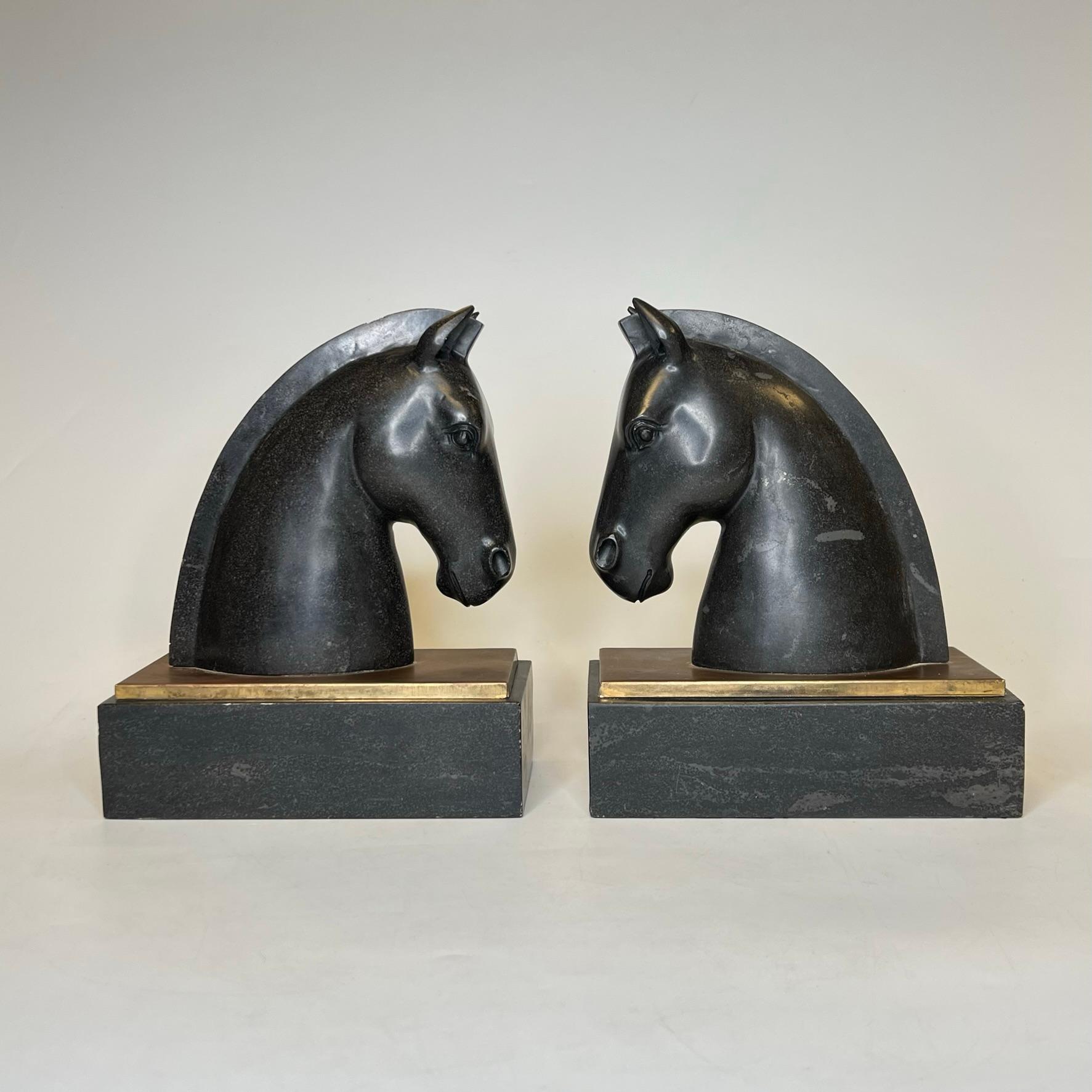 Pair of mid century modern  bronze and marble sculptures of stylized Trojan horses may be used as bookends.  Apparently unsigned.