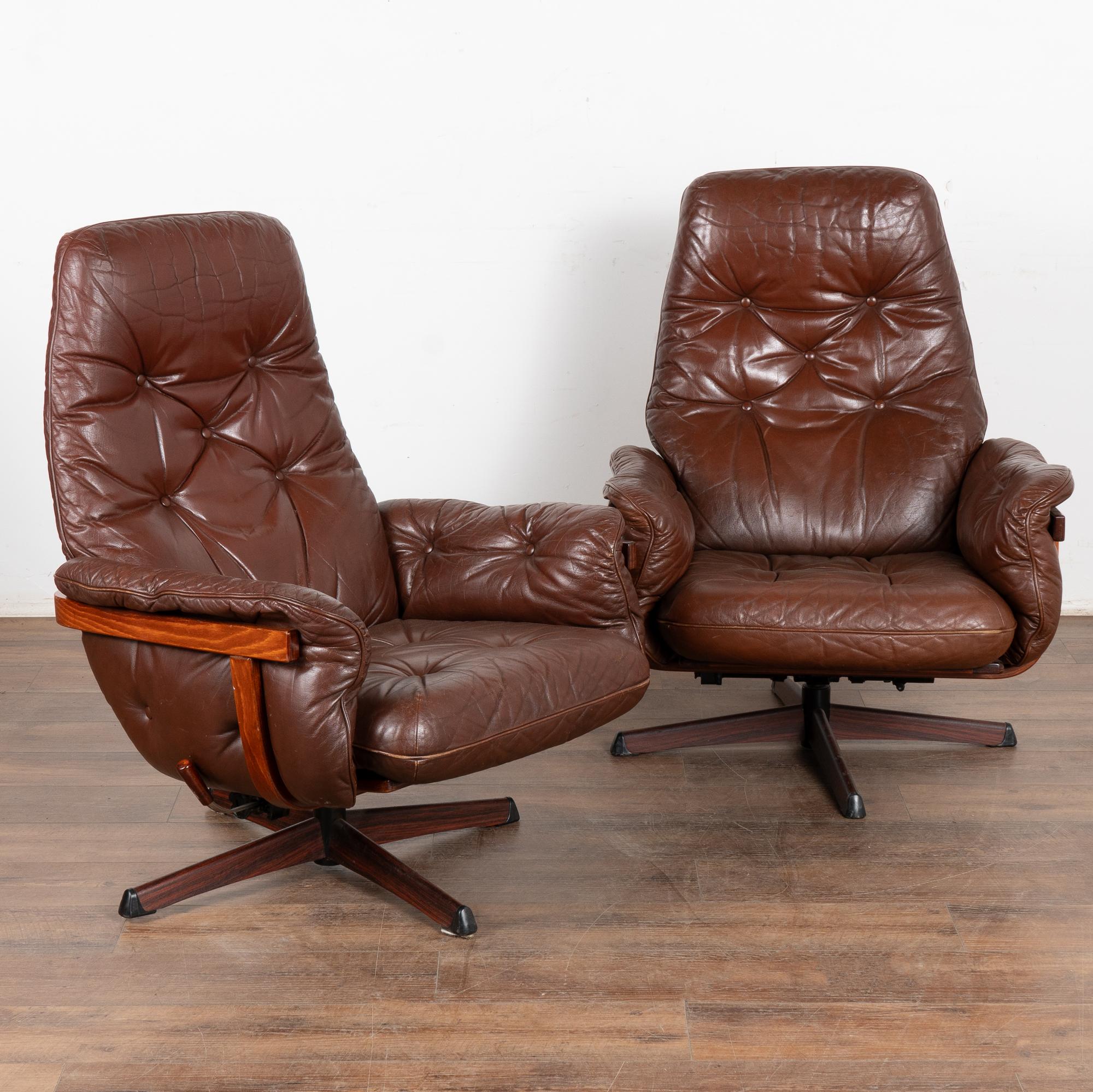 Pair, mid-century modern armchairs with swivel base.
Vintage brown leather cushions are removeable and include zipper openings.
Sold in vintage used condition; this pair sits low and comfortable; swivels easily and also reclines.
Age related use