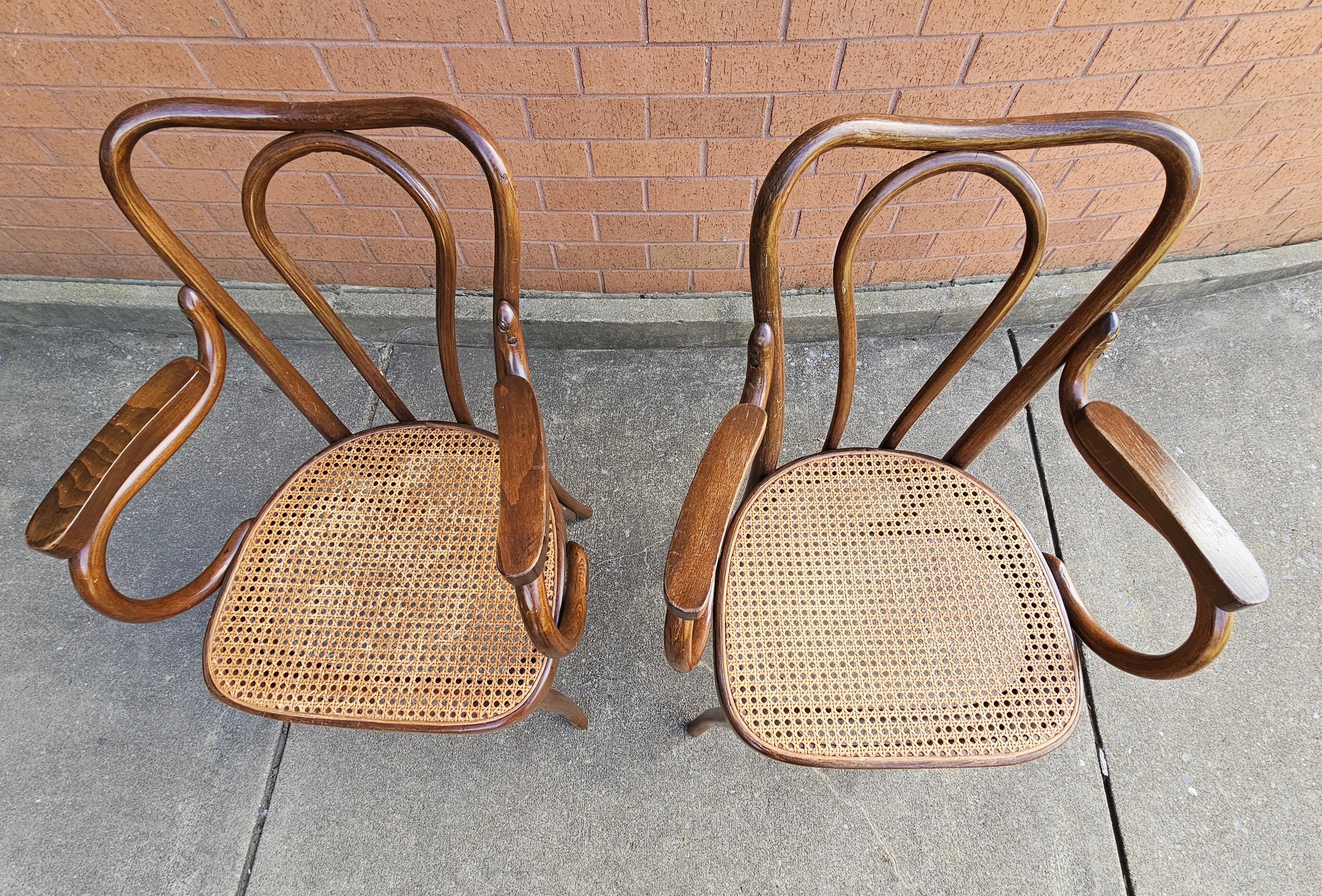 Pair of Mid-Century Thonet Style Bentwood and Cane Arm Chairs in great v8ntage condition. Measure 21