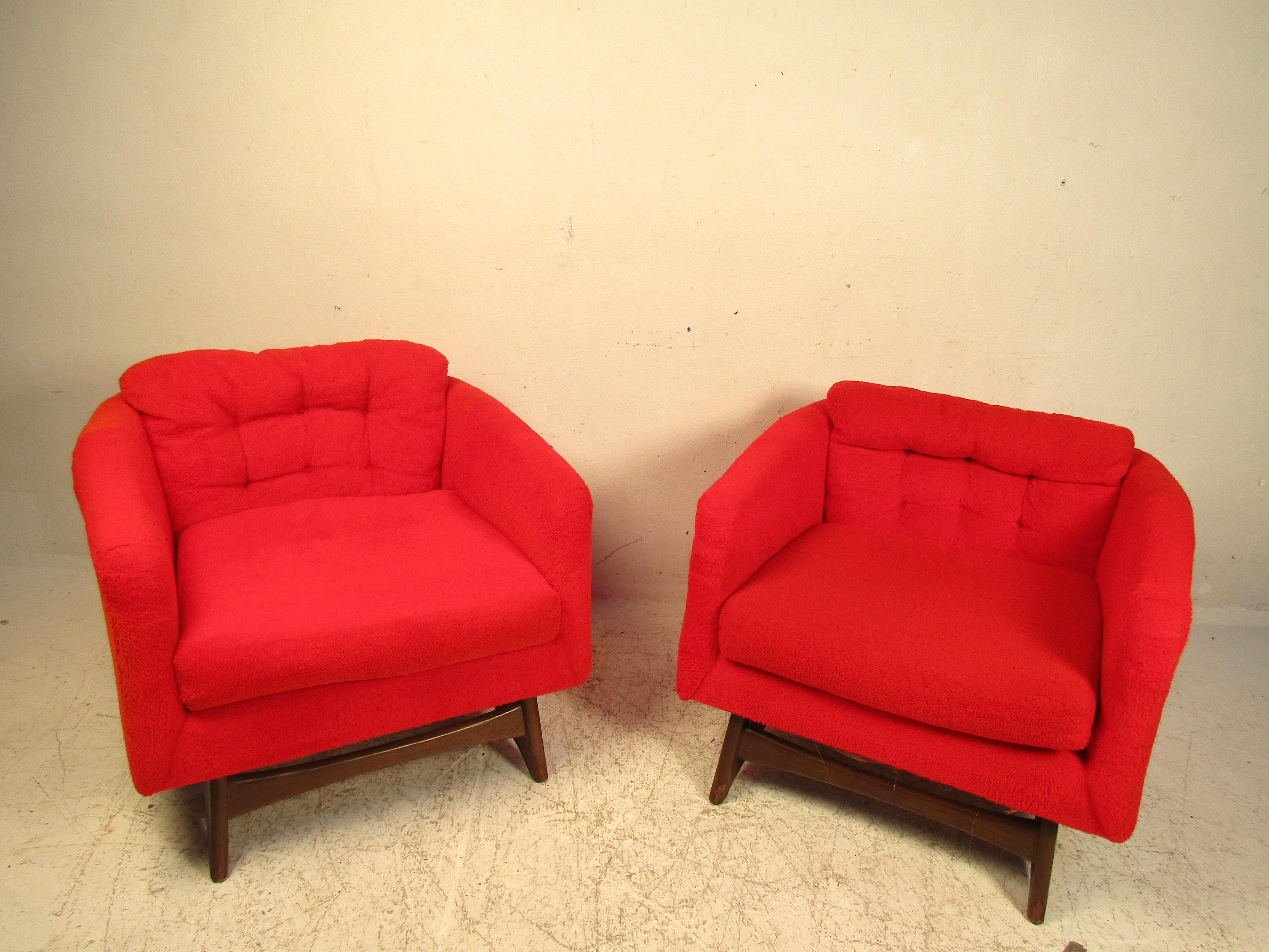 This pair of bold red lounge chairs are done in the styling of famed designer Adrian Pearsall. Featuring bold design and eye-catching style this set will add a fun flair to any living room or bedroom space. Great for entertaining or simply reading a