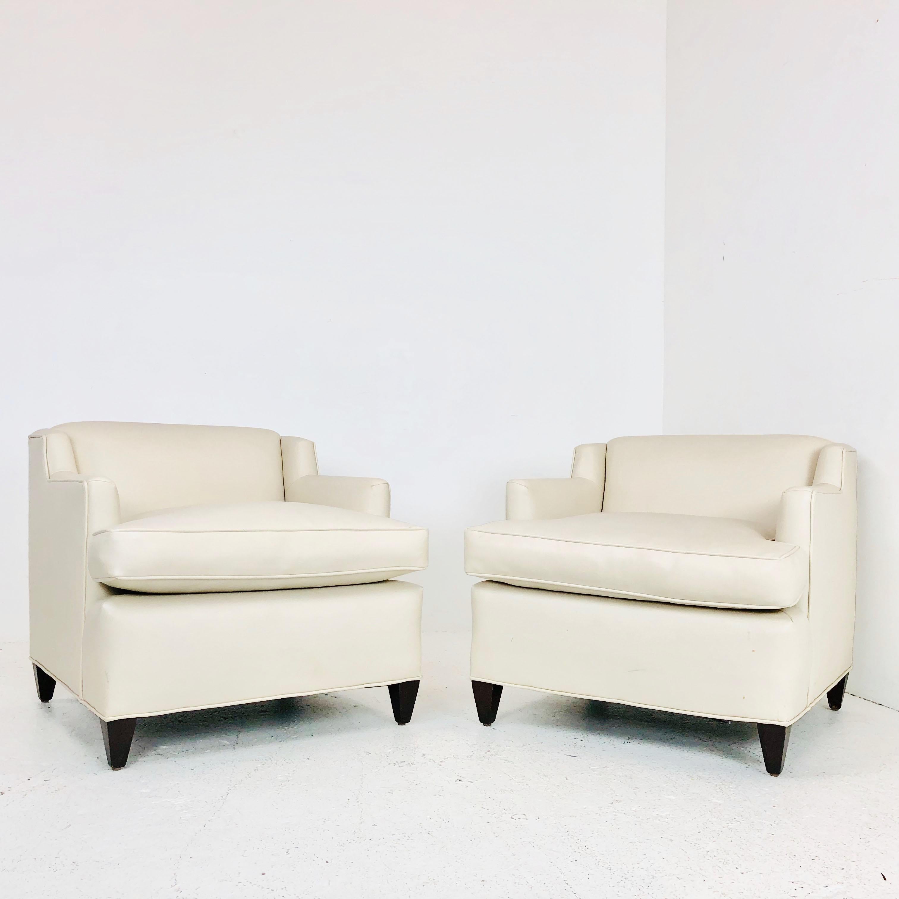 Pair of midcentury Vinyl lounge chairs. These chairs are in good condition and show some wear from use and age. Chairs can be used as-is but recommend new upholstery. 

Dimension:
29 W x 33 D x 28 T
seat height 19.