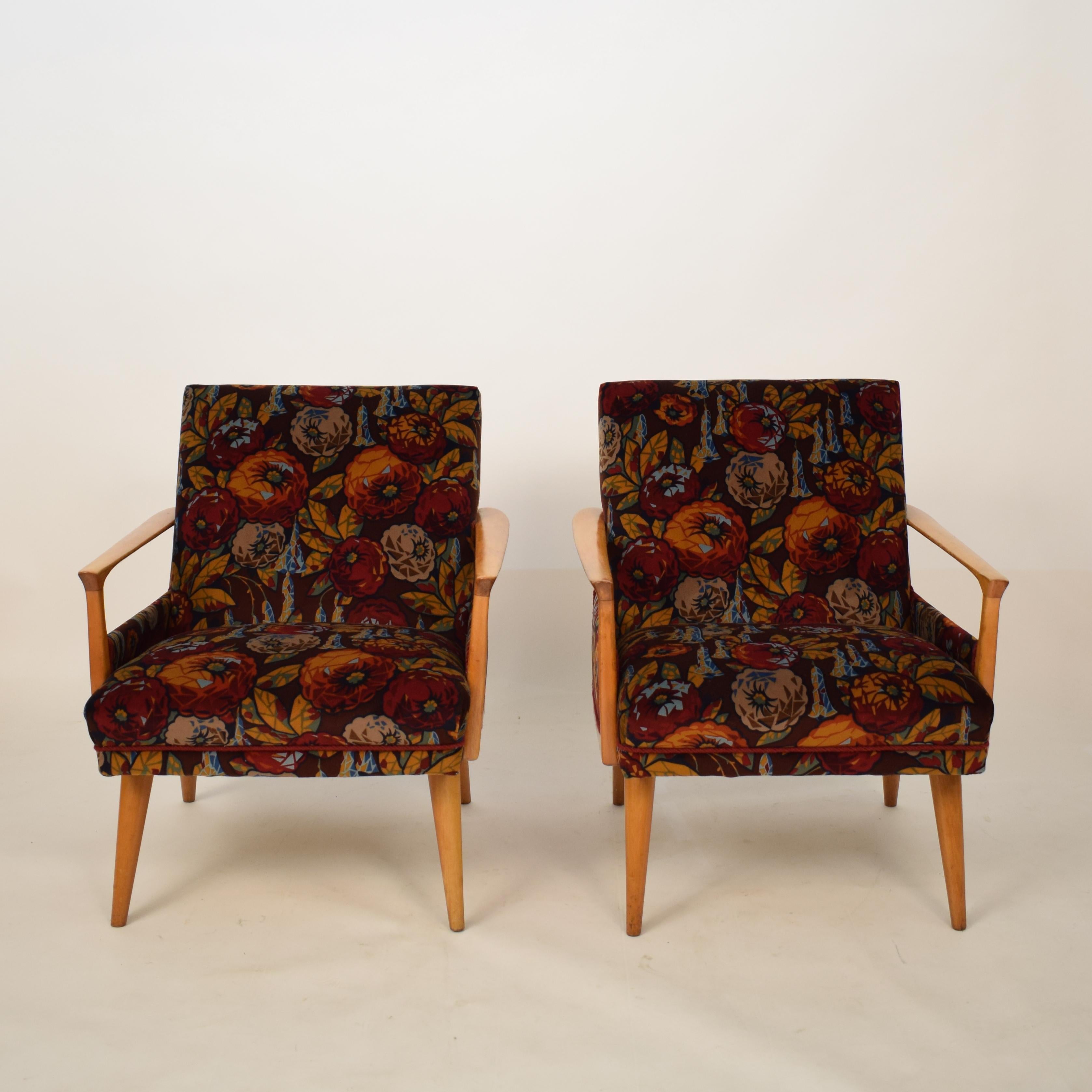 This elegant pair of midcentury armchairs were made in the 1950s in Italy.
The are made out of beech and new upholstered in a multicolored flower velvet. The fabric is designed by Helge Stüssel and produced by Ratti in Italy.
They are very