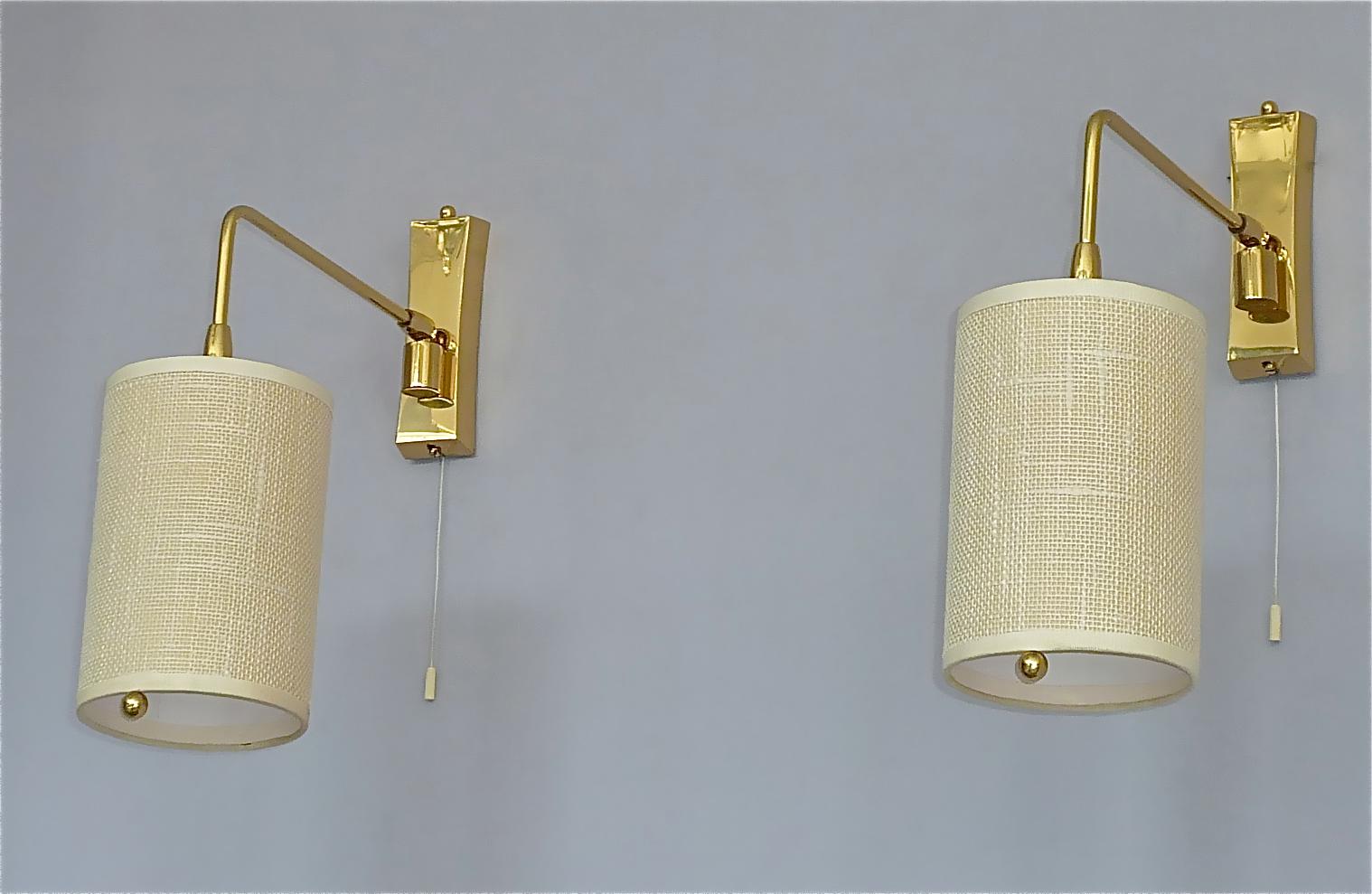 Gorgeous Scandinavian / Austrian pair of wall lamps by Kalmar Austria attribution and very in the style of Paavo Tynell around 1950s. The multifunctional height and side adjustable sconces with string switch have a gilt brass base with movable arm