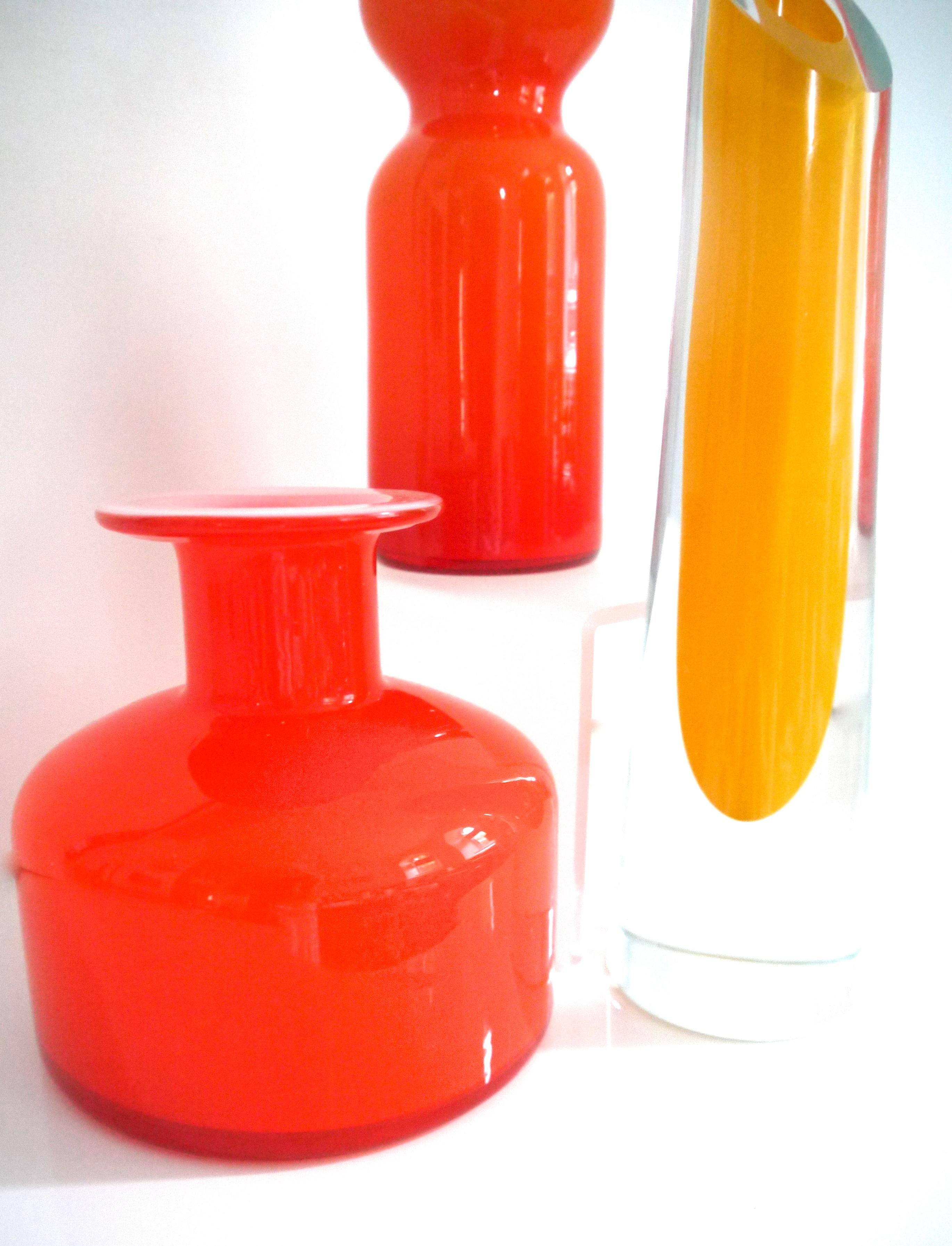 Pair of midcentury orange Kastrup Holmegaard vases in style of PersLutken, 1950s.

Kastrup Glasværk was established by Holmegaard Glasvaerk in 1847 near Copenhagen, in order to manage their bottle production, Kastrup Glassworks was sold in