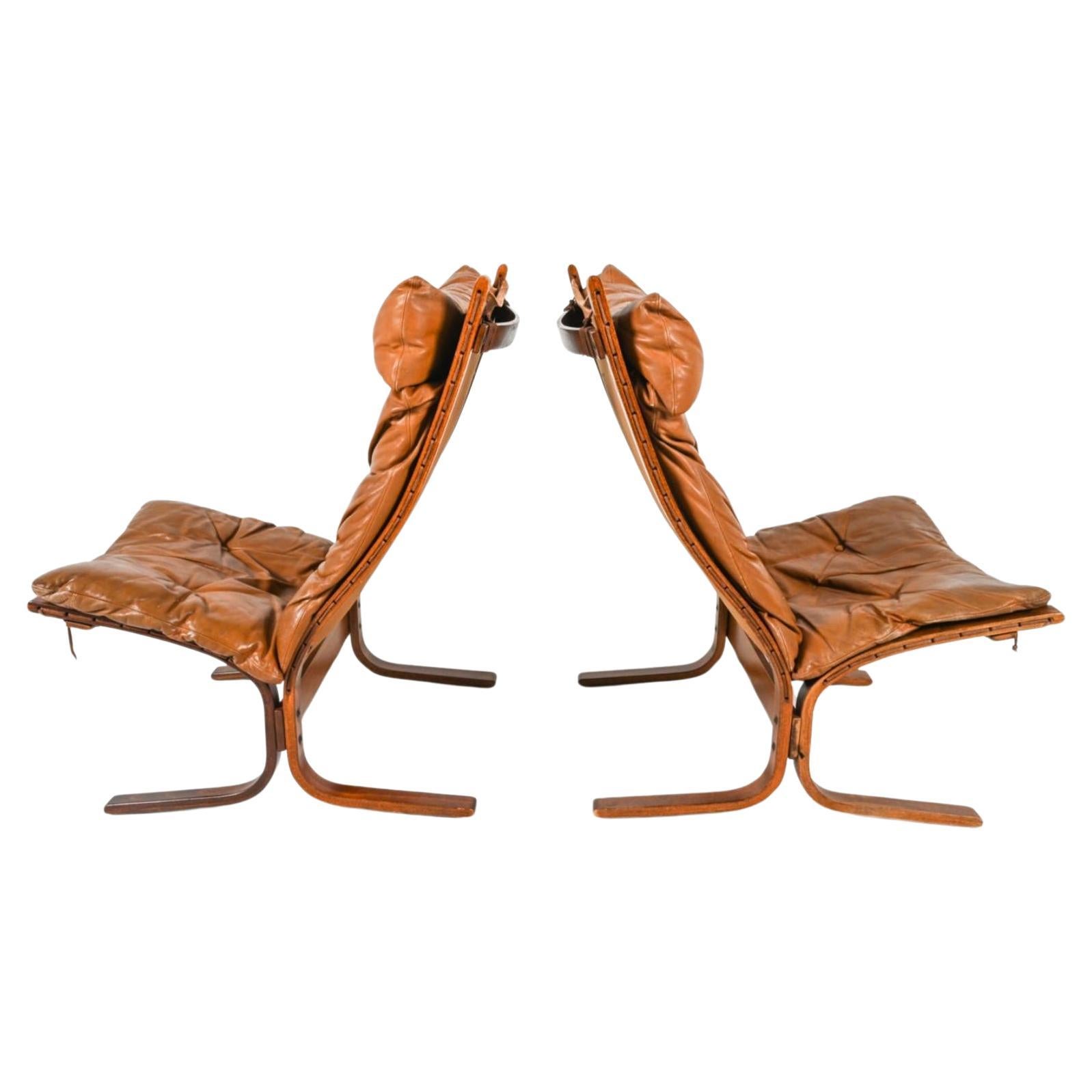 Pair of Midcentury Scandinavian Modern leather High lounge chairs by Westnofa.

(2) Westnofa Norwegian modern High Siesta chairs designed by Ingmar Relling. Dark Rosewood Wooden frames, beautiful worn Tan leather cushions. Bentwood frames and Brown
