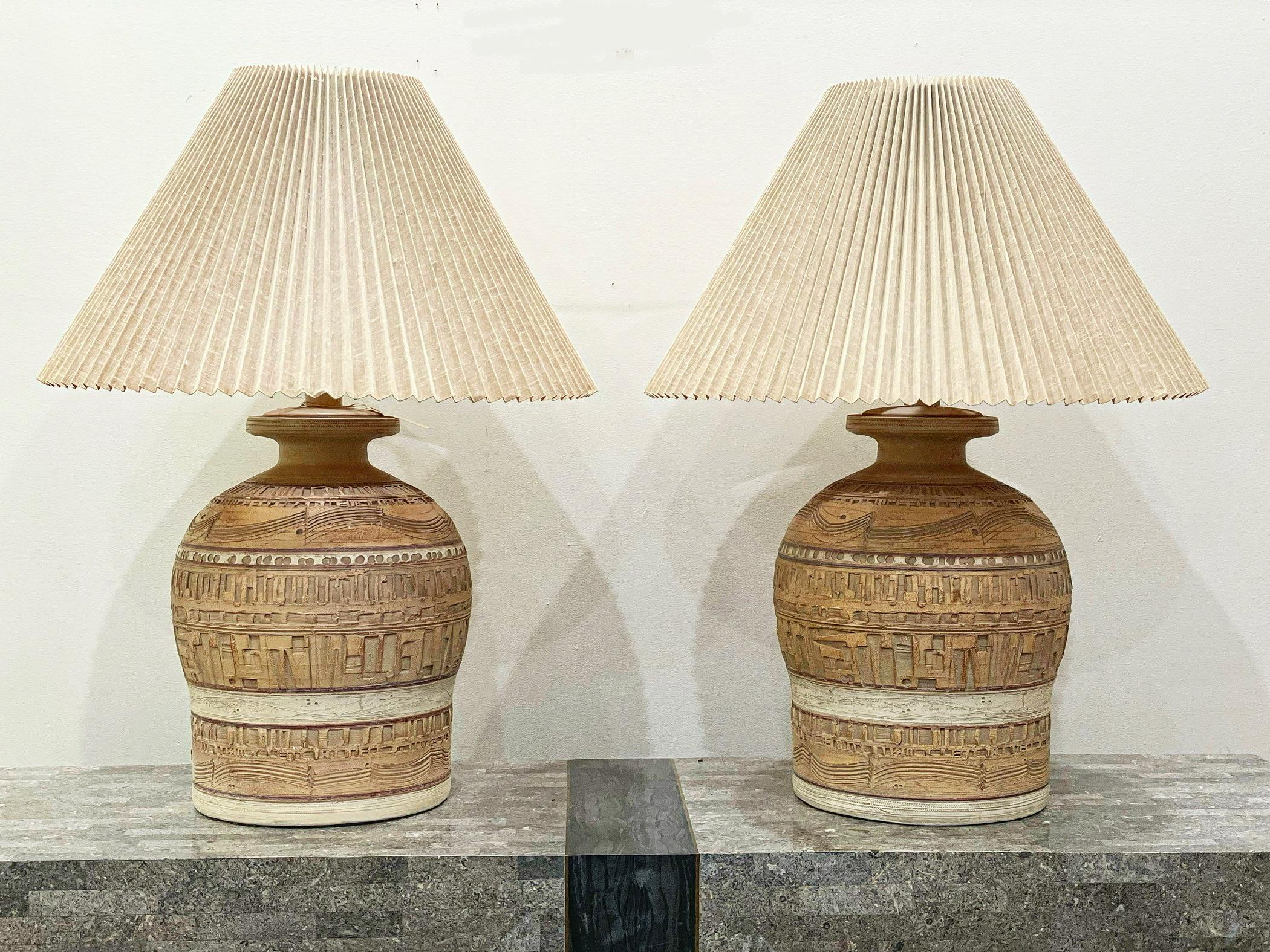 Pair of gorgeous sculpted earthenware ceramic lamps by Casual Lamps of California, circa 1979. Modern organic hand-sculpted motif with muted desert tones of taupes and beiges with hints of rustic pinks. Each is signed 