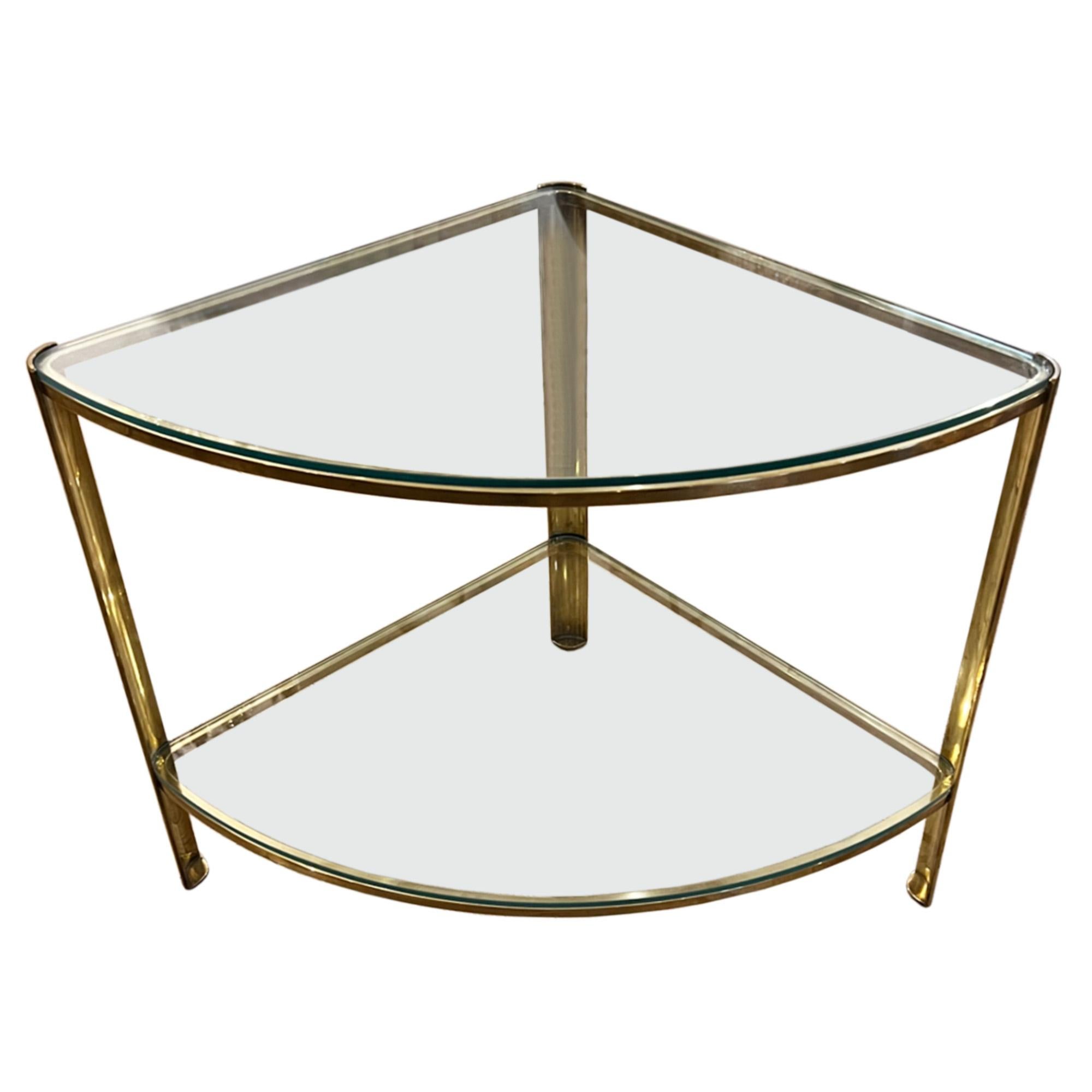 A super stylish design, this pair of elegant side tables are made from brass and glass. 

This is the quarter circle, two tier model and it's difficult to find a pair.

Perfect tables for any living room. The height of the lower shelves is 14cm.
