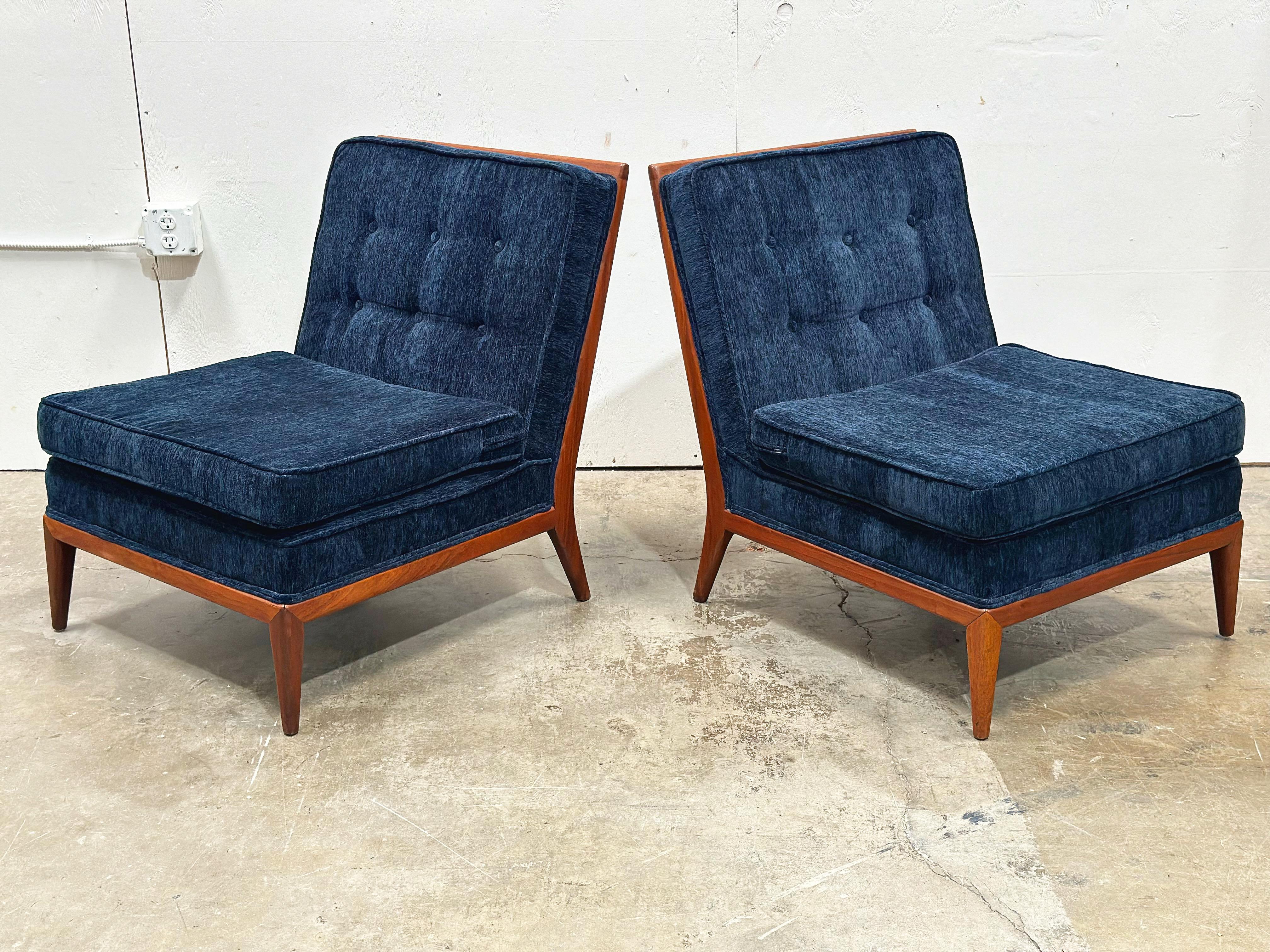Solid sculpted walnut slipper chairs after TH Robsjohn Gibbings. All new blue velvet upholstery. Stout and sturdy American craftsmanship with exquisite refined modern design.
Excellent overall condition. Walnut frames have been cleaned and