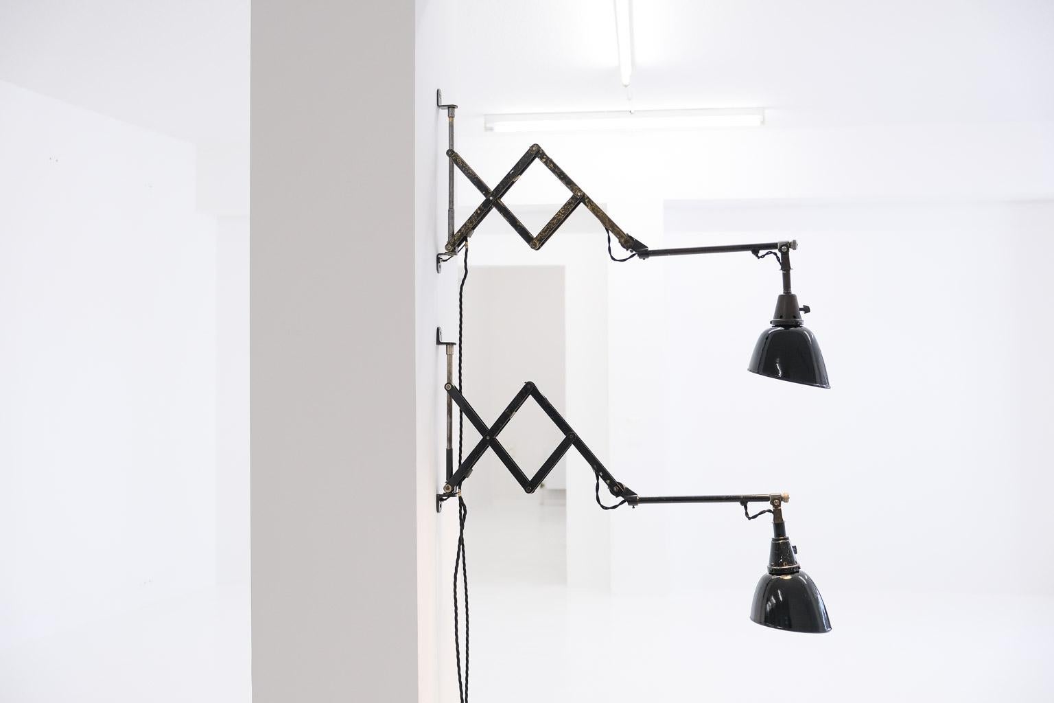 An impressive set of 2 Midgard wall scissor lights, an early version of model 110. Each wall mounted lamp has a length of 116 cm in total. The light can be moved to almost any position at a 180-degree angle. The lamps were lovingly restored in our