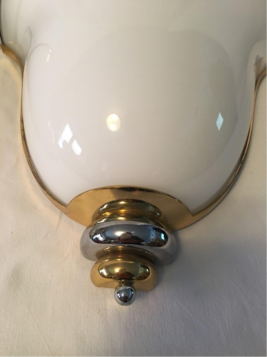 A pair of lovely wall lamps made of milk glass with black holding. It is made of brass with a chrome accent. Made by Prearo of Italy. Each fixture requires one European E26 / E27 Edison bulbs, each bulb up to 60 watts. Rewired to meet U.S. standards.