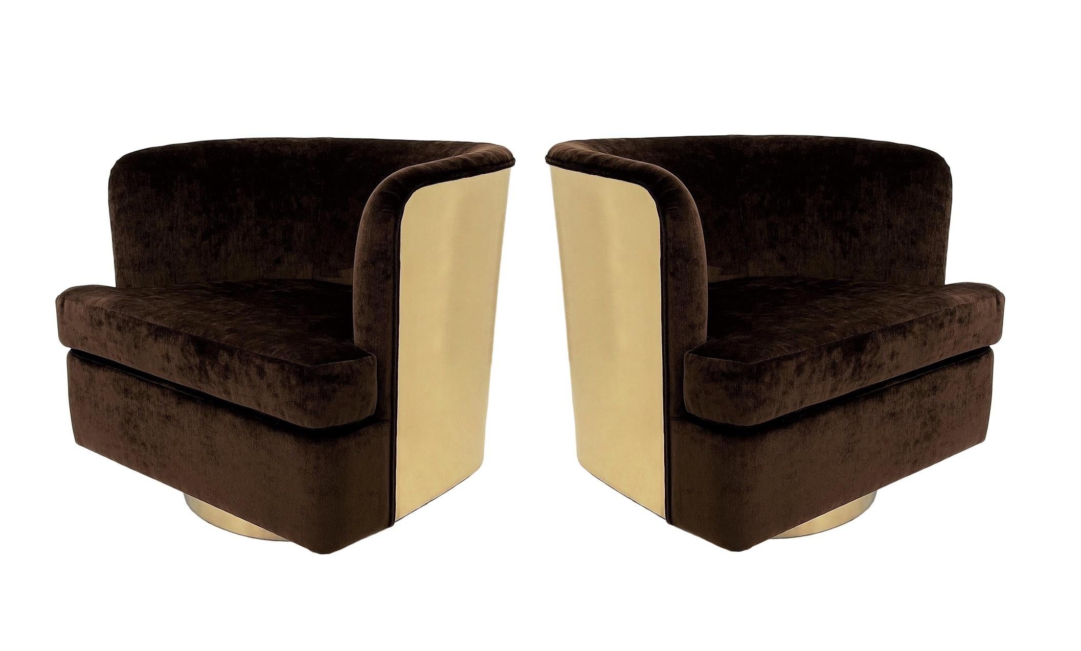 This stunning pair of heirloom quality barrel chairs by Milo Baughman for Thayer Coggin. Super high style, swivel chairs recovered in luxurious brown velvet that contrasts beautifully against the gleaming mirror-finish brass backs and bases. The