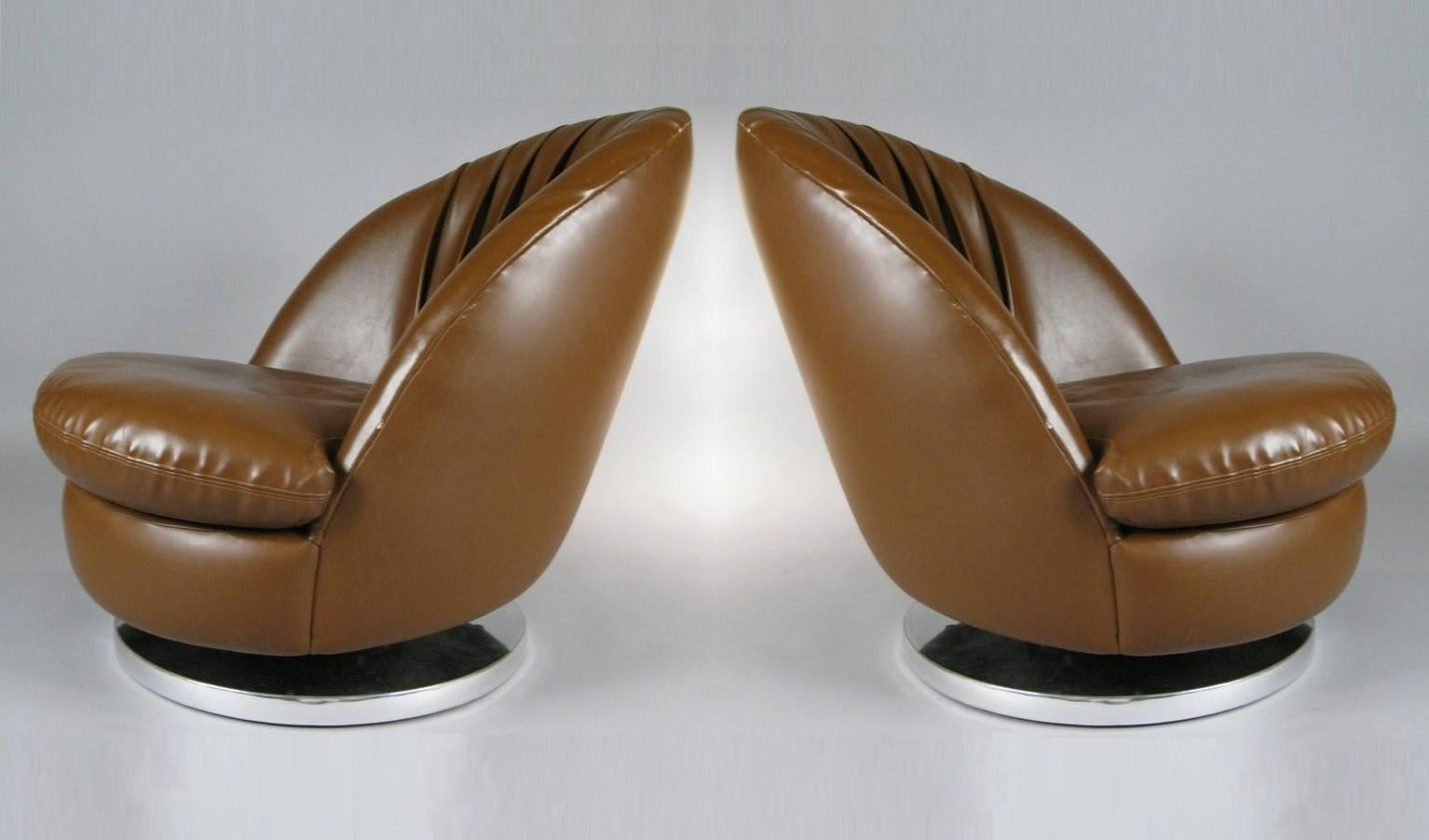 This pair of modern brown chairs designed by Milo Baughman for Thayer Coggin. These chairs are reminiscent of open scallop shells, the seats are deep and comfortable. Chairs rotate 360 degrees, tilt back and are mounted on chrome bases. Their