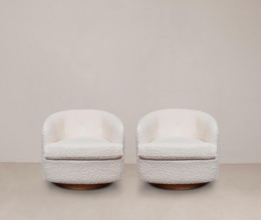 Two signature Milo Baughman swivel chairs designed for Thayer Coggin, North Carolina, circa 1970's. Chairs with streamline barrel back design, fitted with button tufted loose back and removable seat cushion, envelop you in deep comfort. Cascading