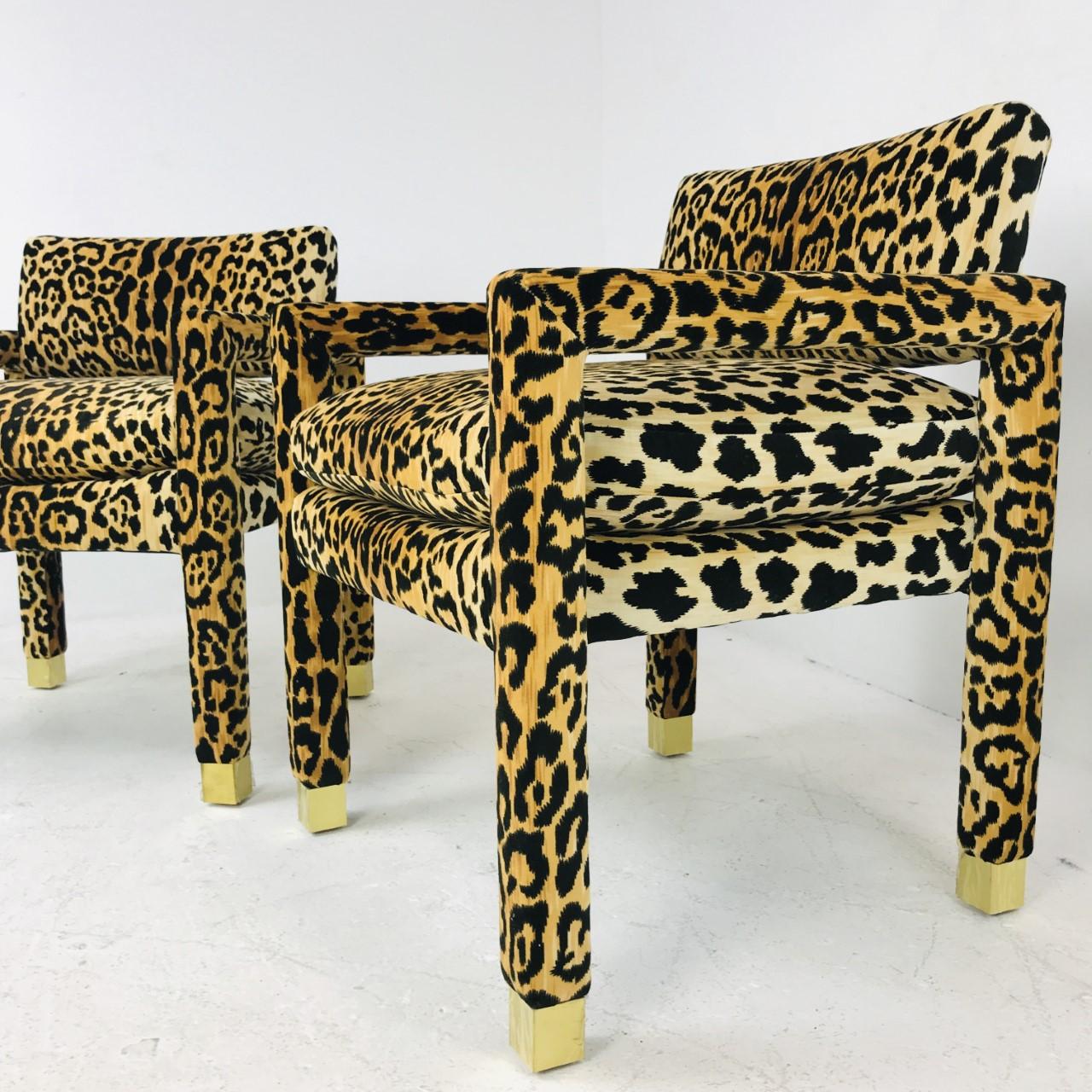Pair of Milo Baughman Parsons chairs with custom brass sabots. Velvet leopard upholstery is new.