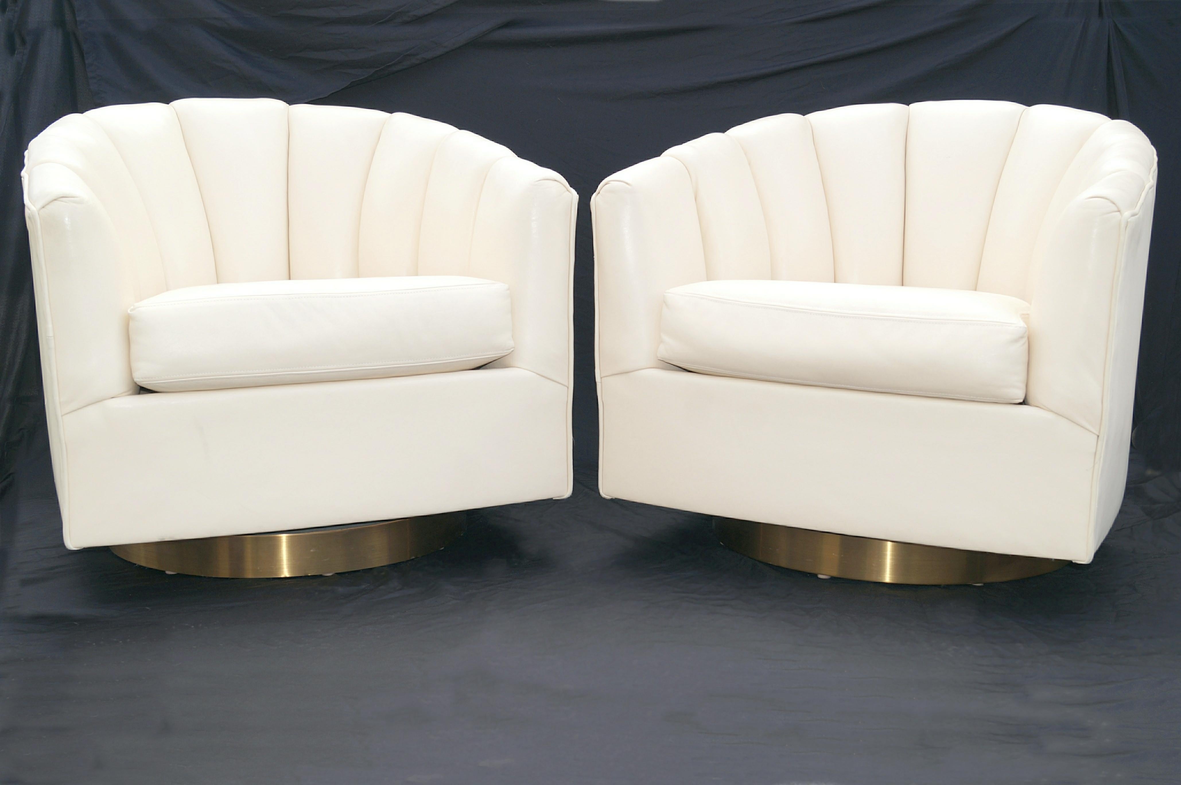 Pair Milo Baughman Style Brass Base Swivel Club Lounge Chairs . These do a swivel 180 turn. The seat cushions appear to be leather, as the underside appears to have hide. See photo. The remainder of the chairs will say Faux leather as we can not see