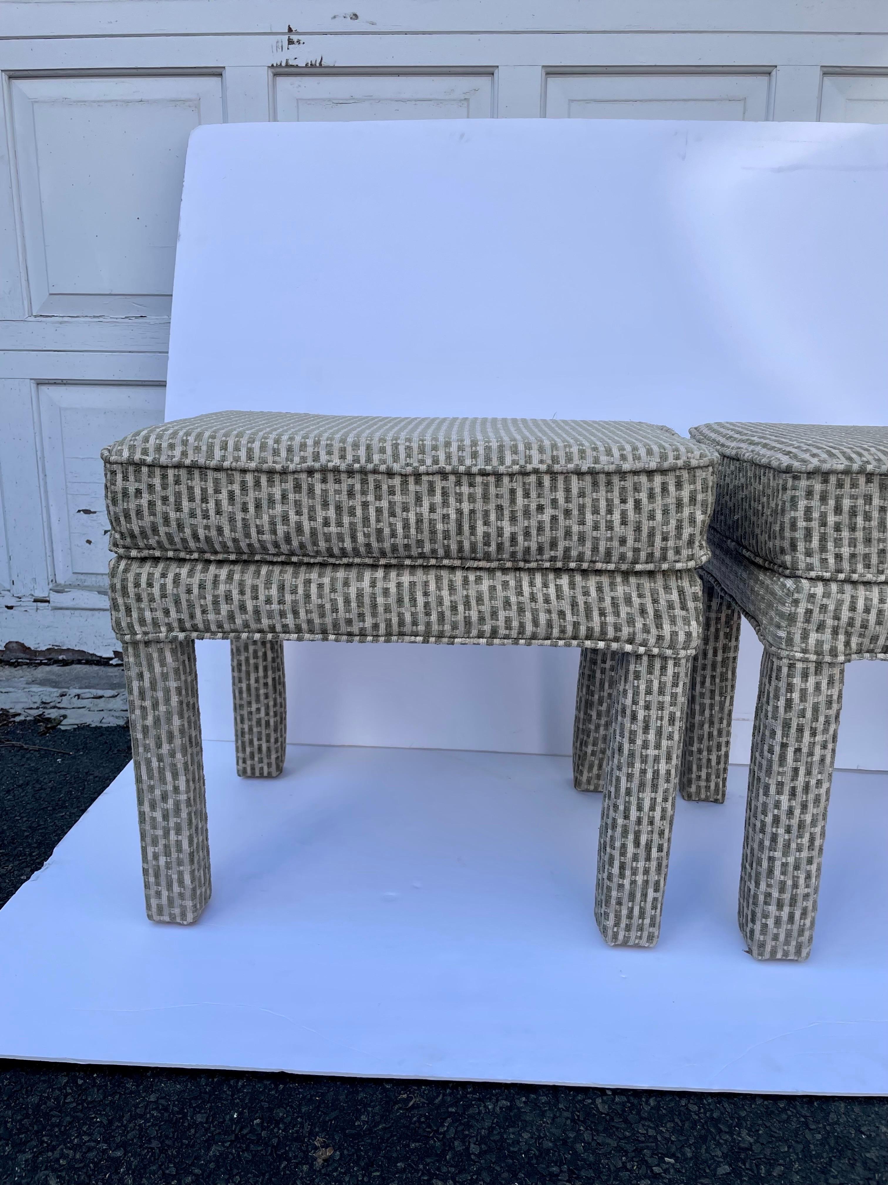 Pair Milo Baughman style upholstered Parsons benches in green and cream upholstery. Good overall condition with slight wear from age and use. Would look amazing reupholstered! Plastic glides on legs and cambric on underside. 