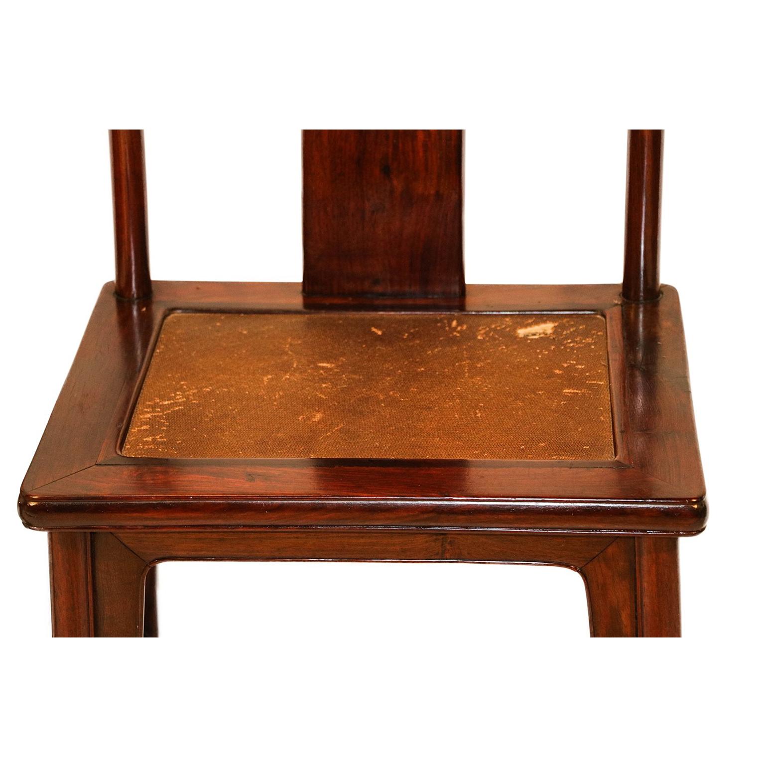 An extraordinary pair of Chinese hardwood chairs crafted in the Ming Dynasty style, late 19th century. Each with inset rectangular panel hard cane seats supporting a wide slightly bowed rectangular back splat flanked by two upright circular posts