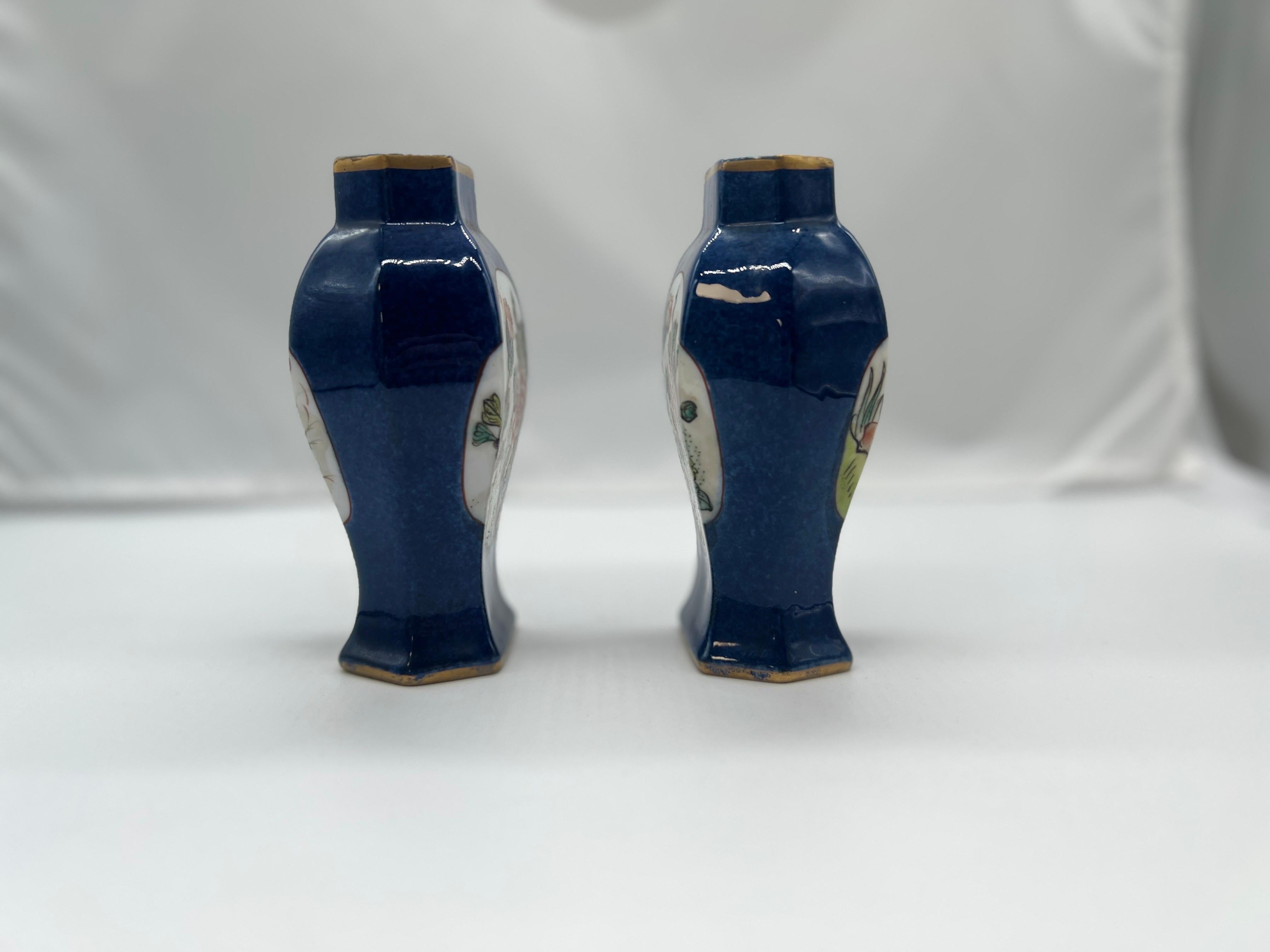 Chinese, likely late Qing Dynasty. 

A pair of porcelain urn or vases with a rich blue cobalt ground body accented by matched floral enameled windows to each side. Unmarked to underside. 

Provenance: From the estate of a Newport businessman.