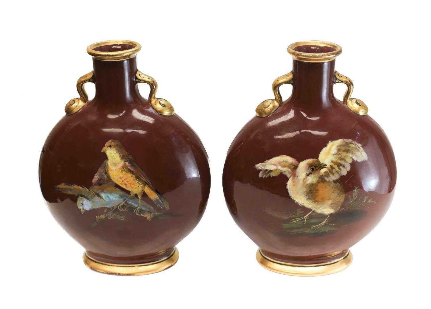 Pair of Minton porcelain moon flasks by William Mussill, 1871. Charming hand painted flowers to one side of the vases with birds to the verso. Minton mark to the underside. Weight approximate 3 lbs 

Measures approximate 6.25