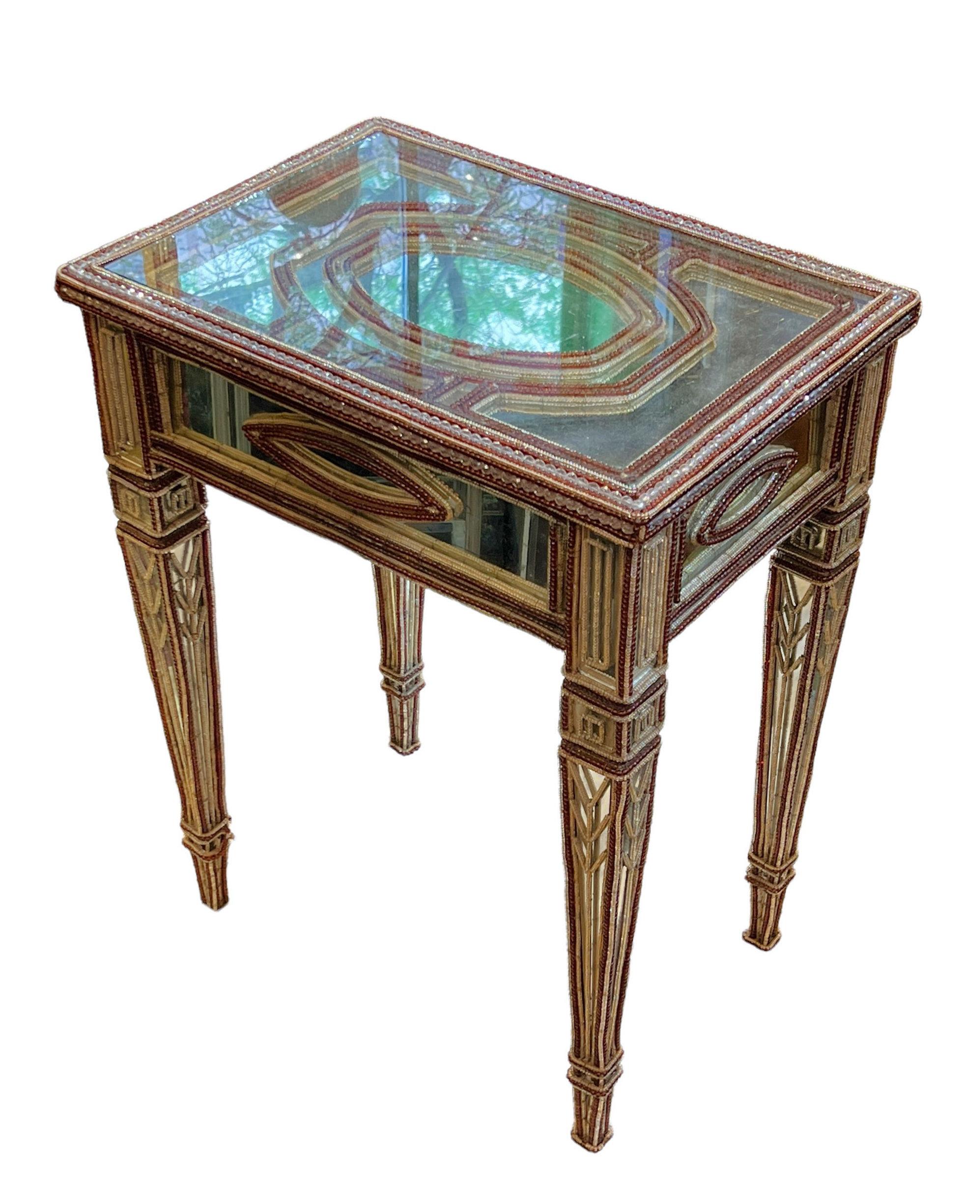 Our pair of side tables from the early 20th century feature mirrored surfaces on the tops and friezes, and extensive clear and ruby red colored glass beads. A classic design, but relatively rare. Each in good condition.