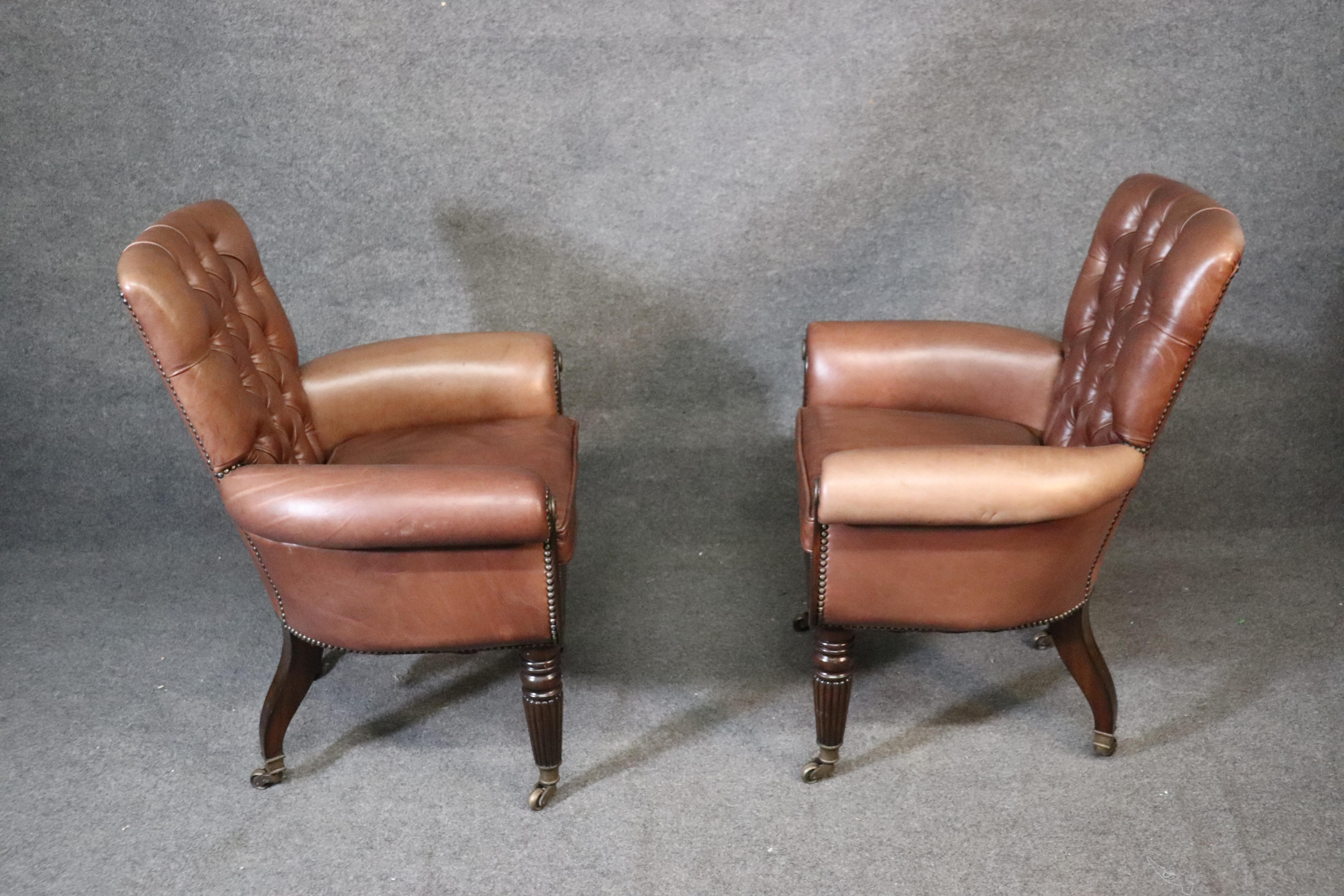 This is a pair of gorgeous mocha brown genuine top-grain leather chairs in the Georgian style with terrific hand carved mahogany frames, circa 2000. They are in very good condition with minimal wear as they are less than 20 years old. They measure