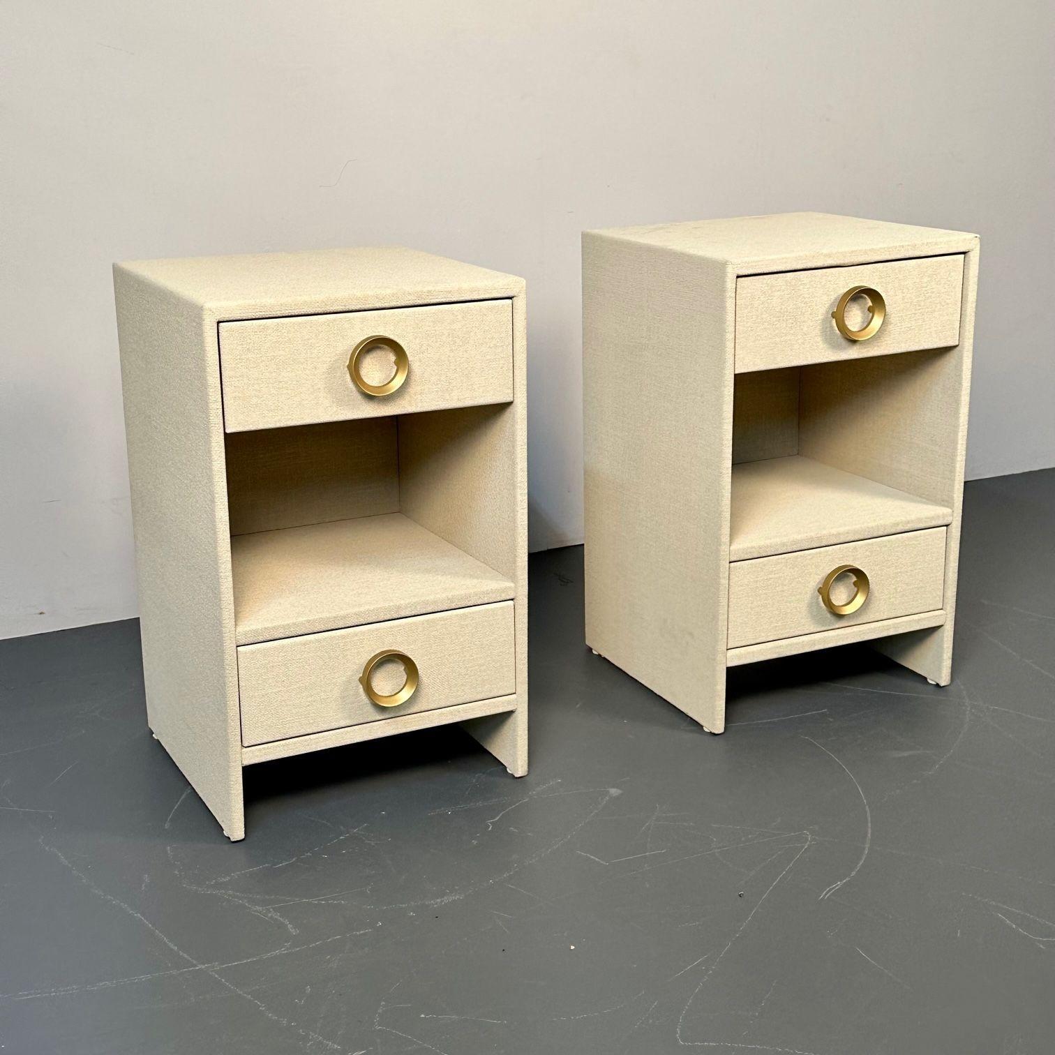 Pair modern beige linen wrapped two drawer open nightstands, end or side tables.
 
Custom made modern beige linen wrapped two drawer open nightstands. The pair having a lower and upper drawers flanking an open compartment. Contemporary decorative