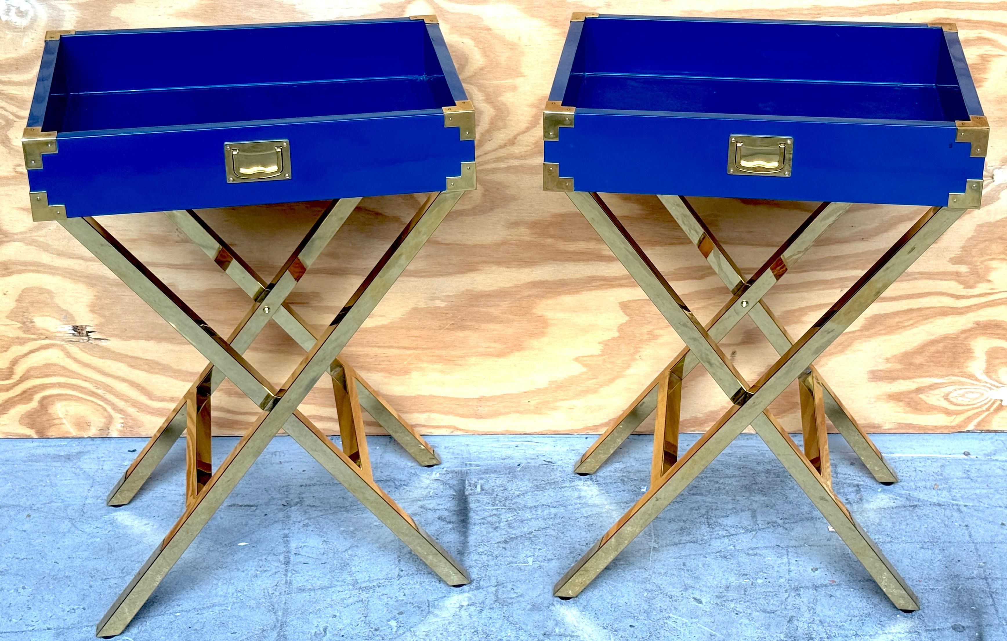 Pair Modern Blue Lacquered Campaign-Style Tray Tables with Gilt Metal X-Bases, Attributed to Made Goods

A distinctive pair of all-over campaign-style tray tables attributed to Made Goods, crafted with fixed blue lacquer trays and gilt metal X-form