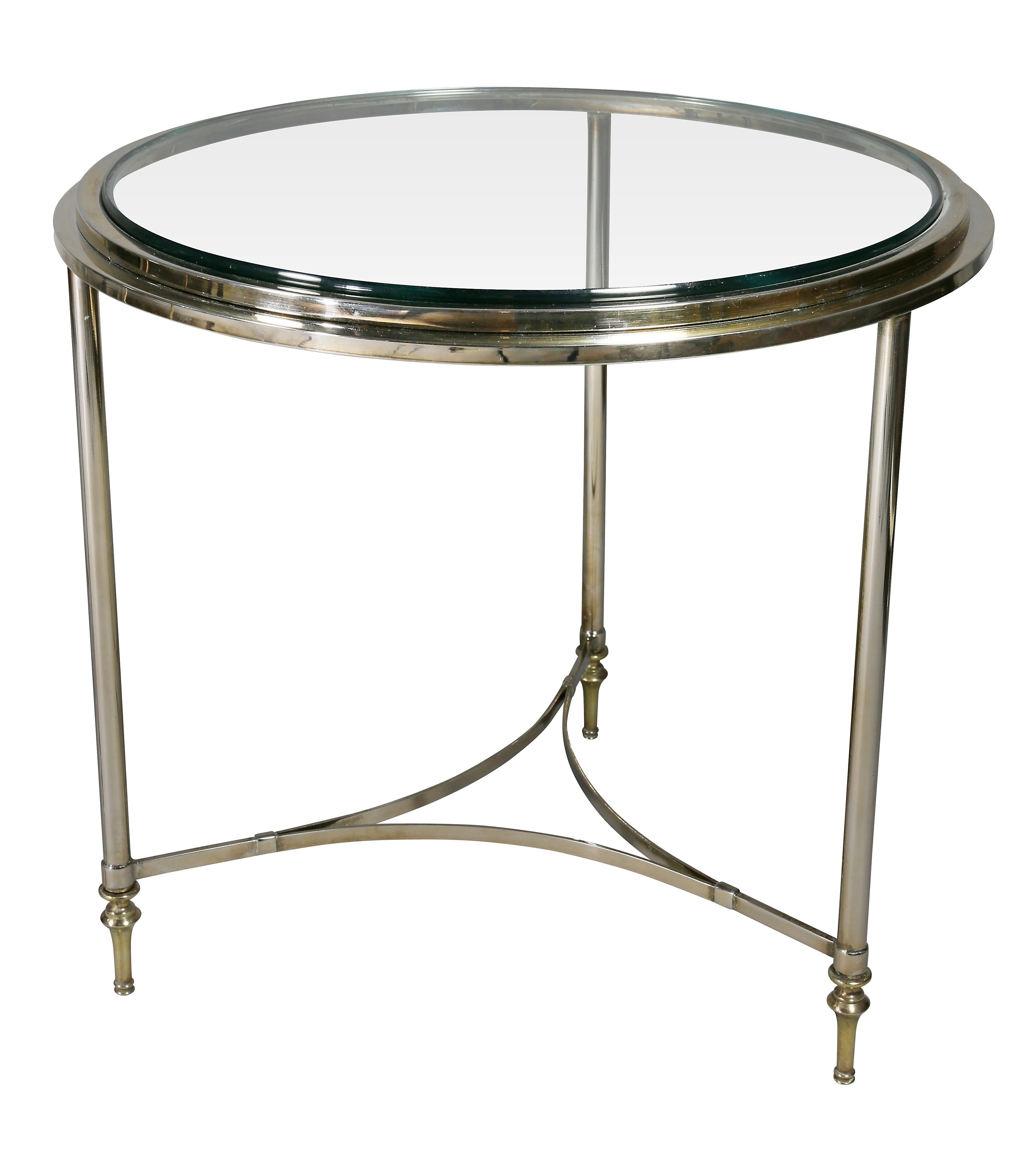From the 1970s. Circular with glass inserts, three circular tapered legs and stretchers.