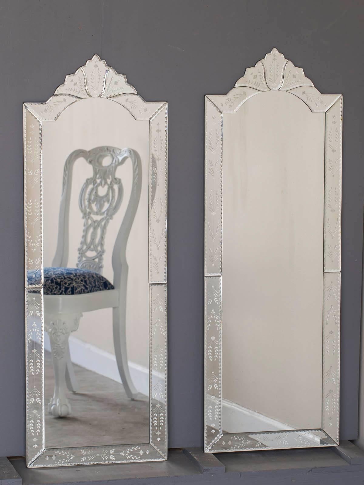 Tall and slender and just like the girl from Ipanema this pair of modern Venetian glass mirrors has a narrow width compared to the height. Each mirror is composed of ten individually made sections of etched mirror glass surrounding the central