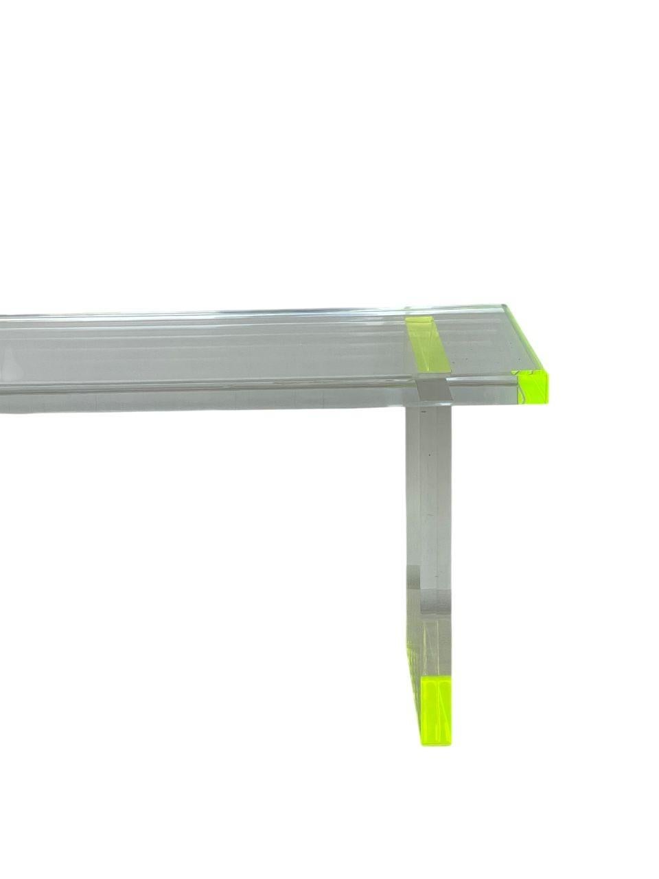Striking pair of modern benches designed by Pegaso Gallery Design, crafted from solid 1.5-inch thick Lucite. These benches feature clean minimalist lines enhanced with fluorescent green accents, adding a vibrant pop of color while maintaining a