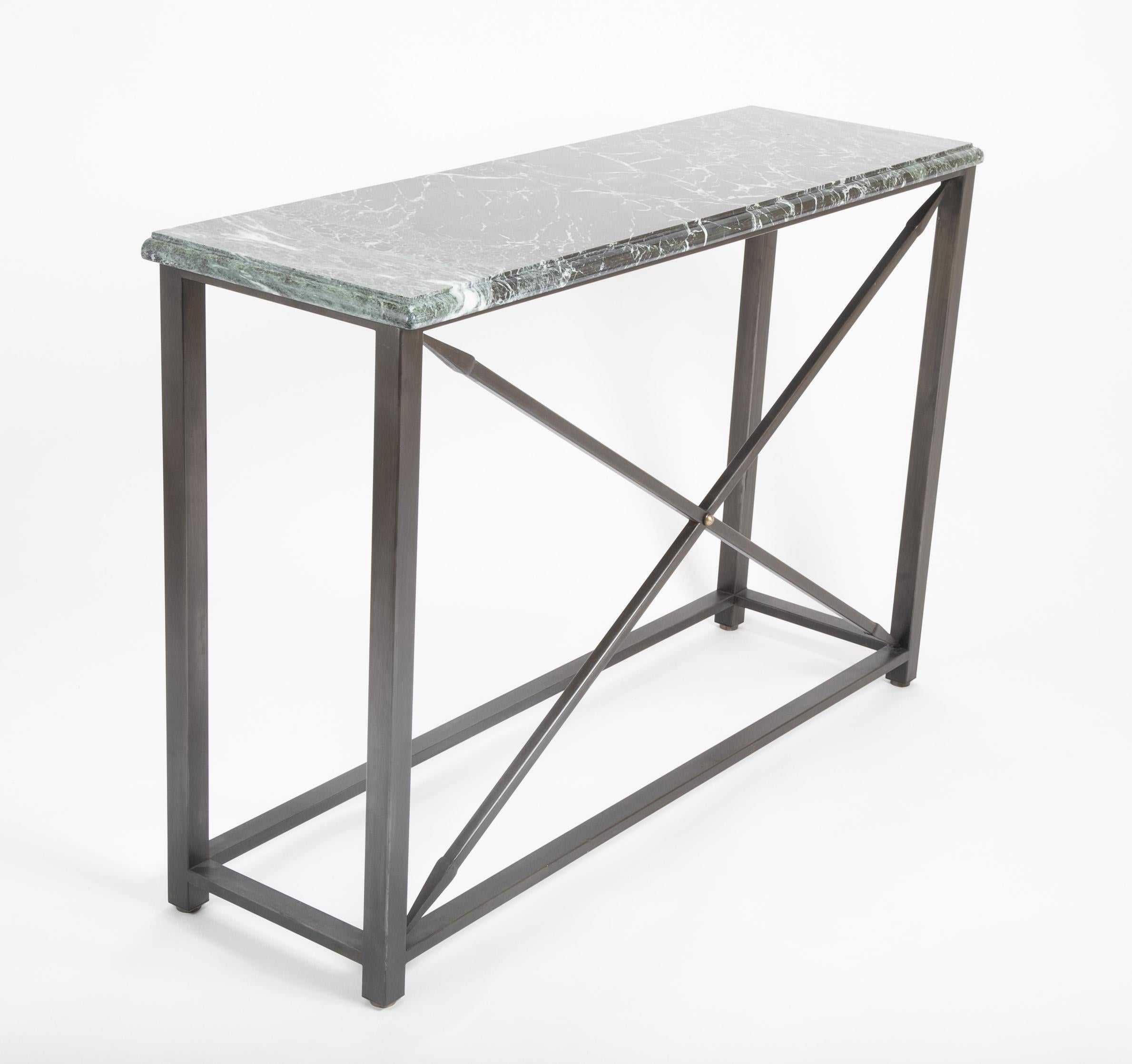 Custom made pair of Neoclassical style console tables with steel X-form bases topped with very handsome Verdi Antico marble. The deep green marble veined with white carved with ogee edge. The X-form stretchers with spear heads on both ends. A clean,