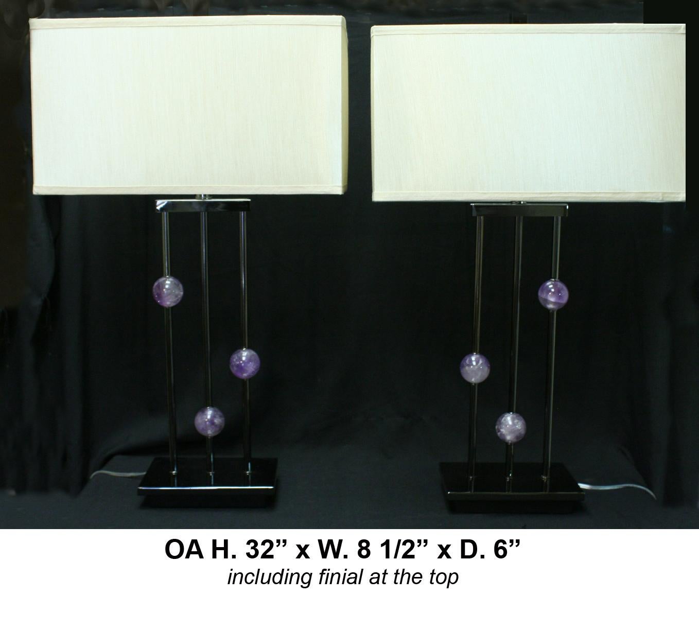 Opposing pair of modern style hand carved and hand-polished Amethyst quartz and chromed metal lamps with rectangular shades.

 