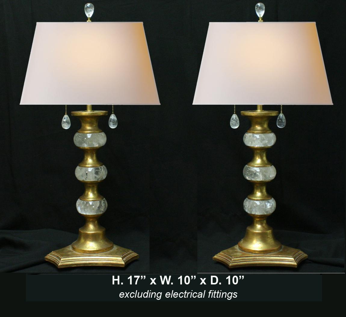 Lovely pair of modern style hand carved and hand polished rock crystal and 22-karat gold leaf giltwood table lamps with rock crystal pulls and finials.

Shades included.
         