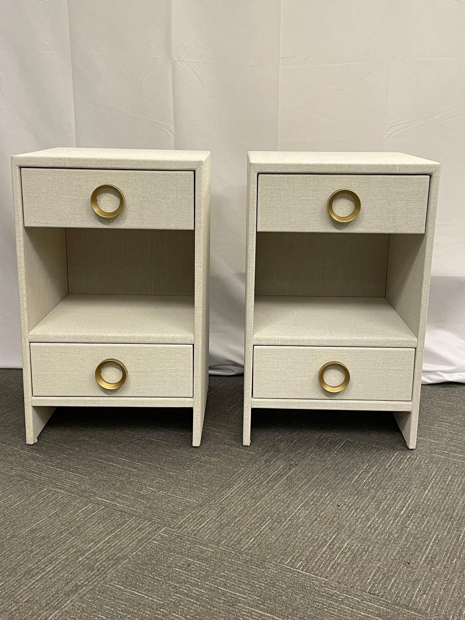 Pair modern white linen wrapped nightstands, end, side tables, brasmodern white linen wrapped nightstands, end, side tables, brass, American.
A decorator designer dream are these custom made Modern White Linen Wrapped Two Drawer Open Nightstands.