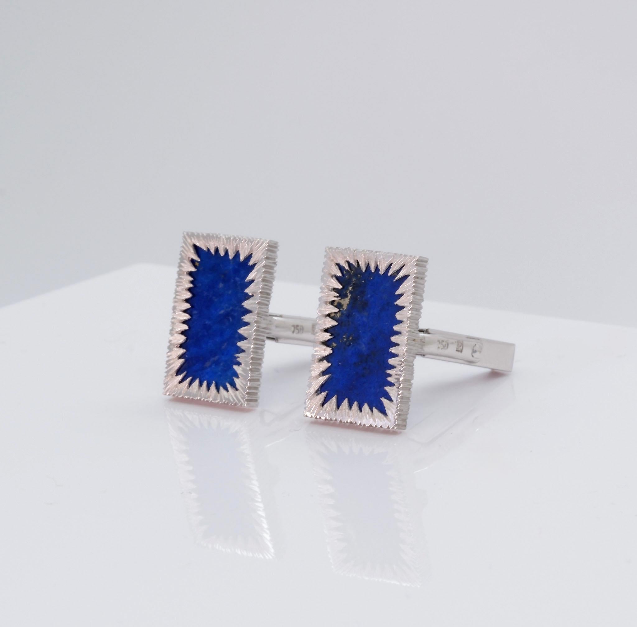 A superb pair of Modernist 18ct white gold and lapis lazuli cufflinks. Stamped 'seven hundred and fifty'  along with maker's mark 'R'. Circa 1970's. European.

 Each having rectangular lapis lazuli plaques, overlaid with a starburst surround, with