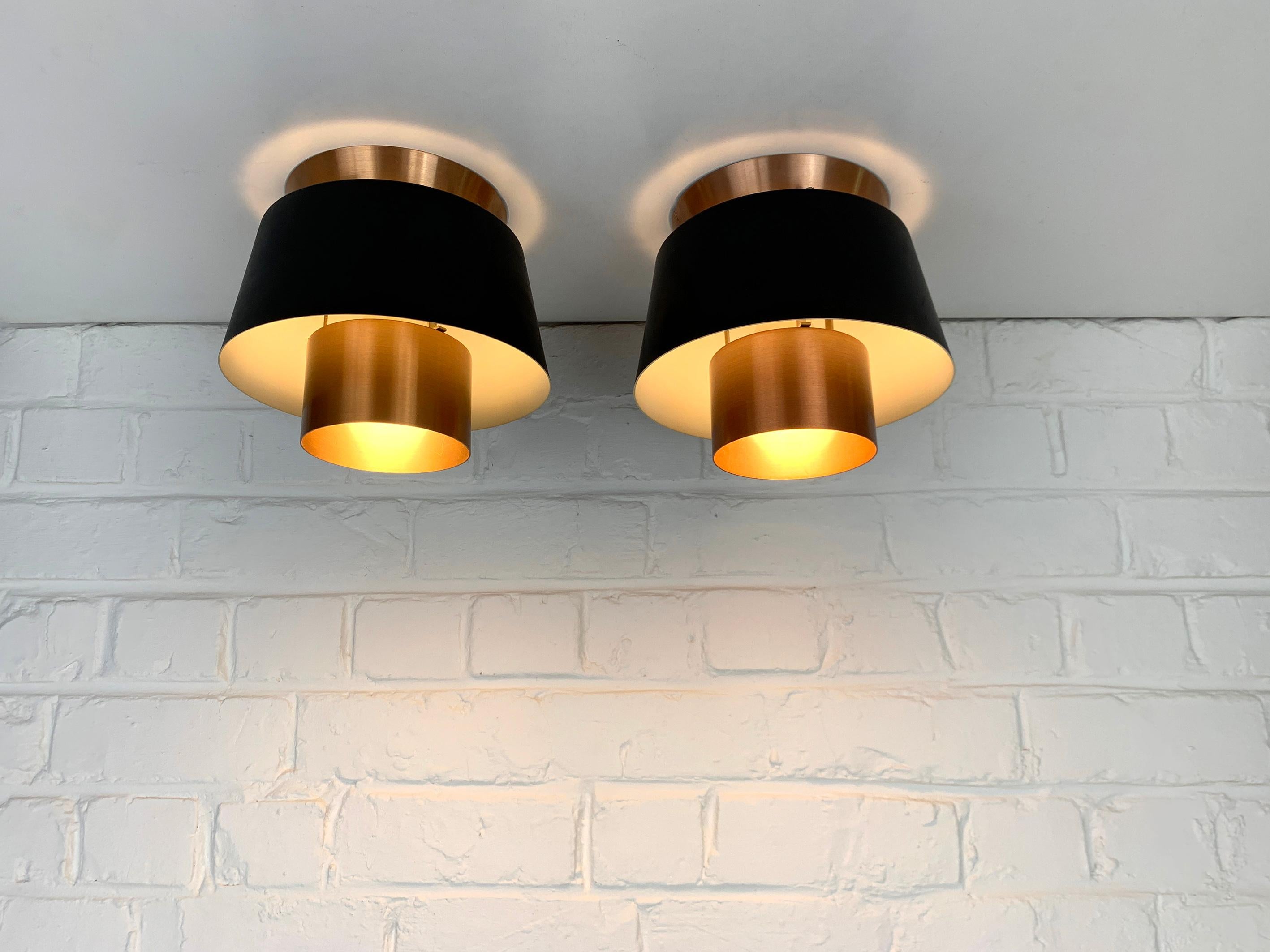 Pair vintage Tivoli flush mount lamps in black & copper finish. Manufactured by Nordisk Solar during the 1950s or 1960s.

The Tivoli pendant was designed in 1947 by Danish architect Jørn Utzon, long before his renowned win of the architectural