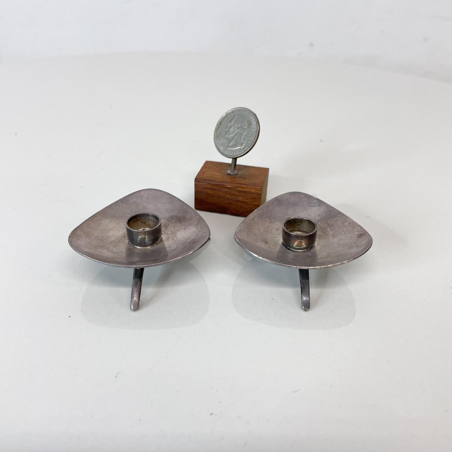 Pair of danish modern silver plated candle holders by COHR ATLA Denmark. 
Characterized by modernist form tripod base with lovely sculptural shape. 
Maker stamped. Candle holders by Atla designed by Carl M. Cohr Denmark 1960s.
Measures: .63 H x 2.13