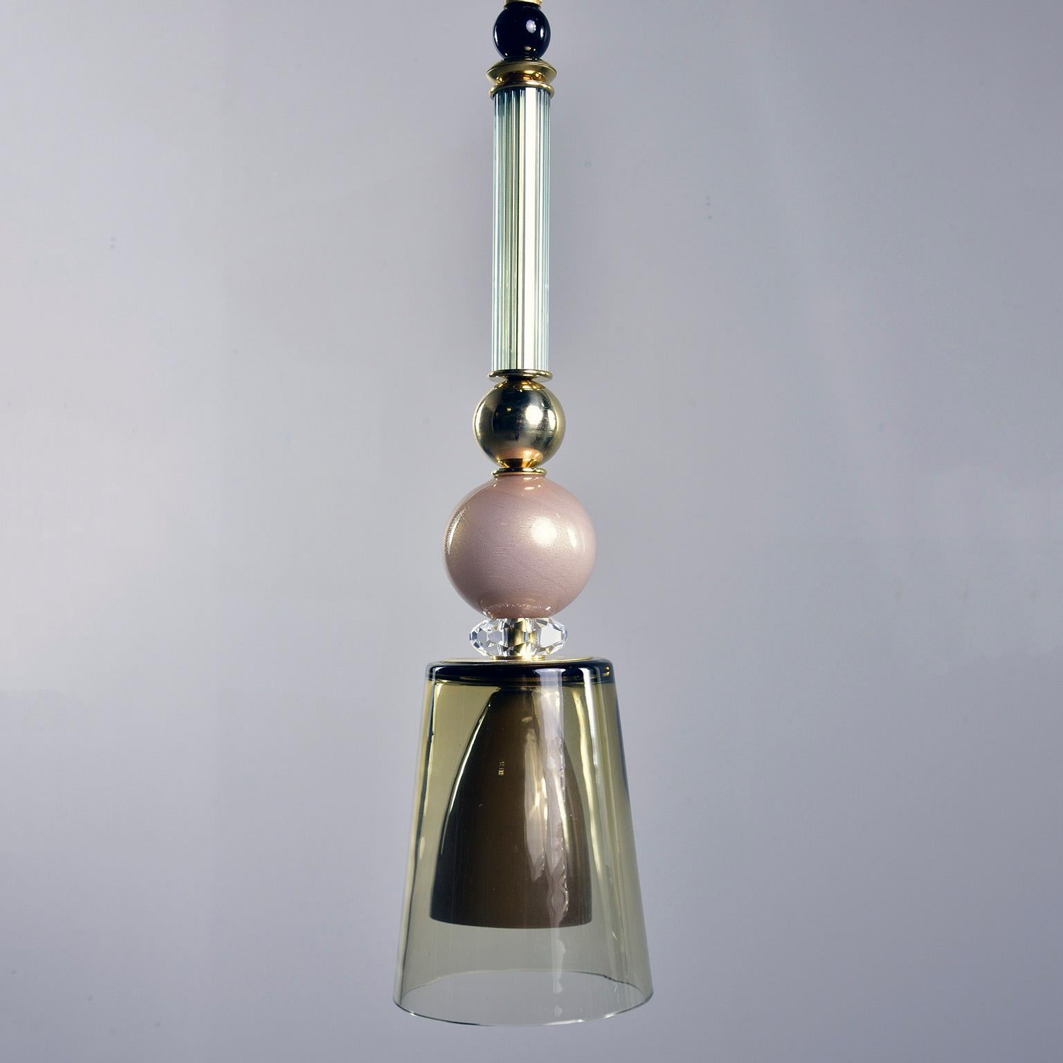 Pair of new Italian glass and brass pendant lights feature multi-color Murano glass elements in shades of green, pink and black. The pale pink Murano glass spheres are infused with gold and the pendants have accents of clear crystal and polished