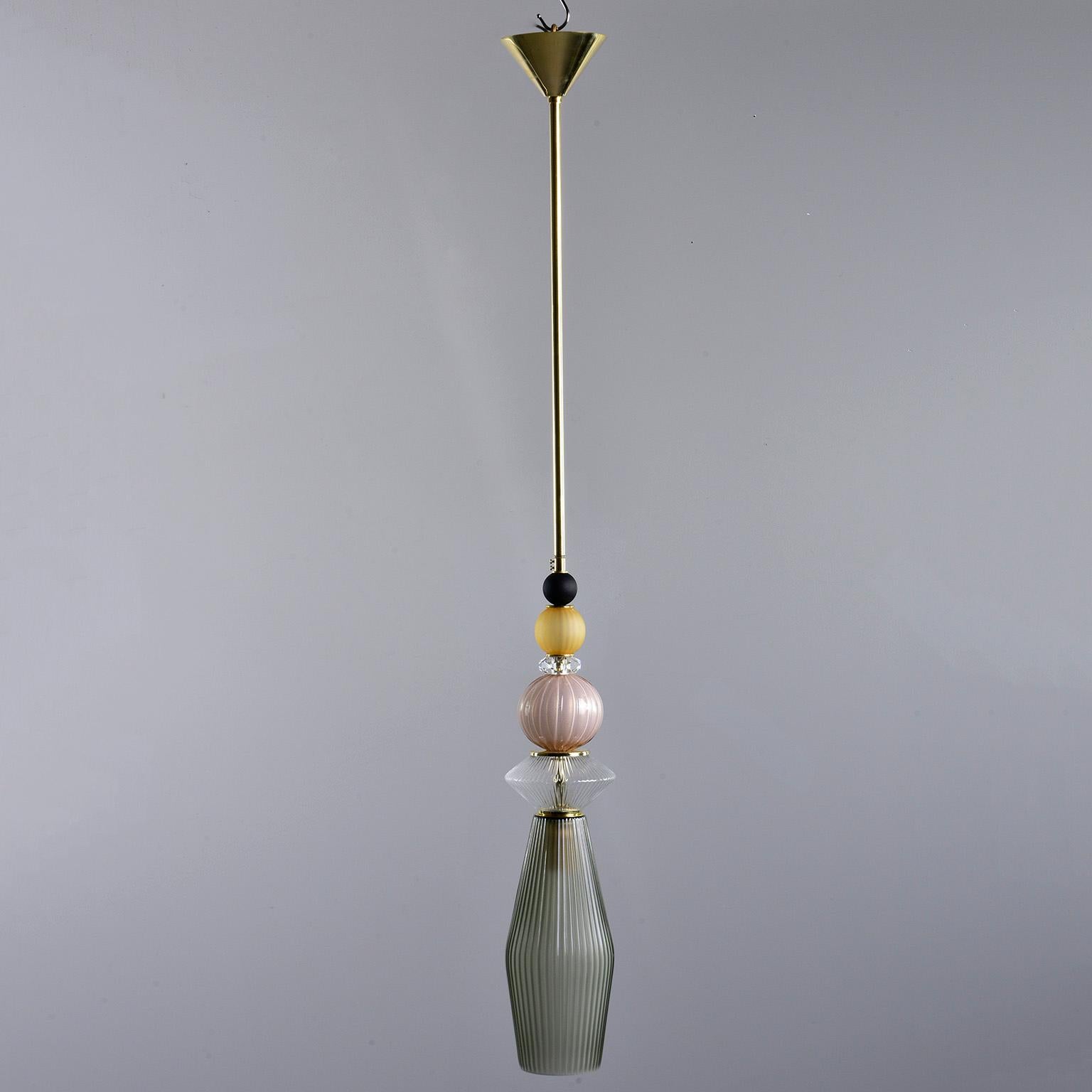 Pair of circa 2010 pendant lights made of multi-color Murano glass elements with brass rods and canopy. New wiring for US electrical standards. Sold and priced as a pair.