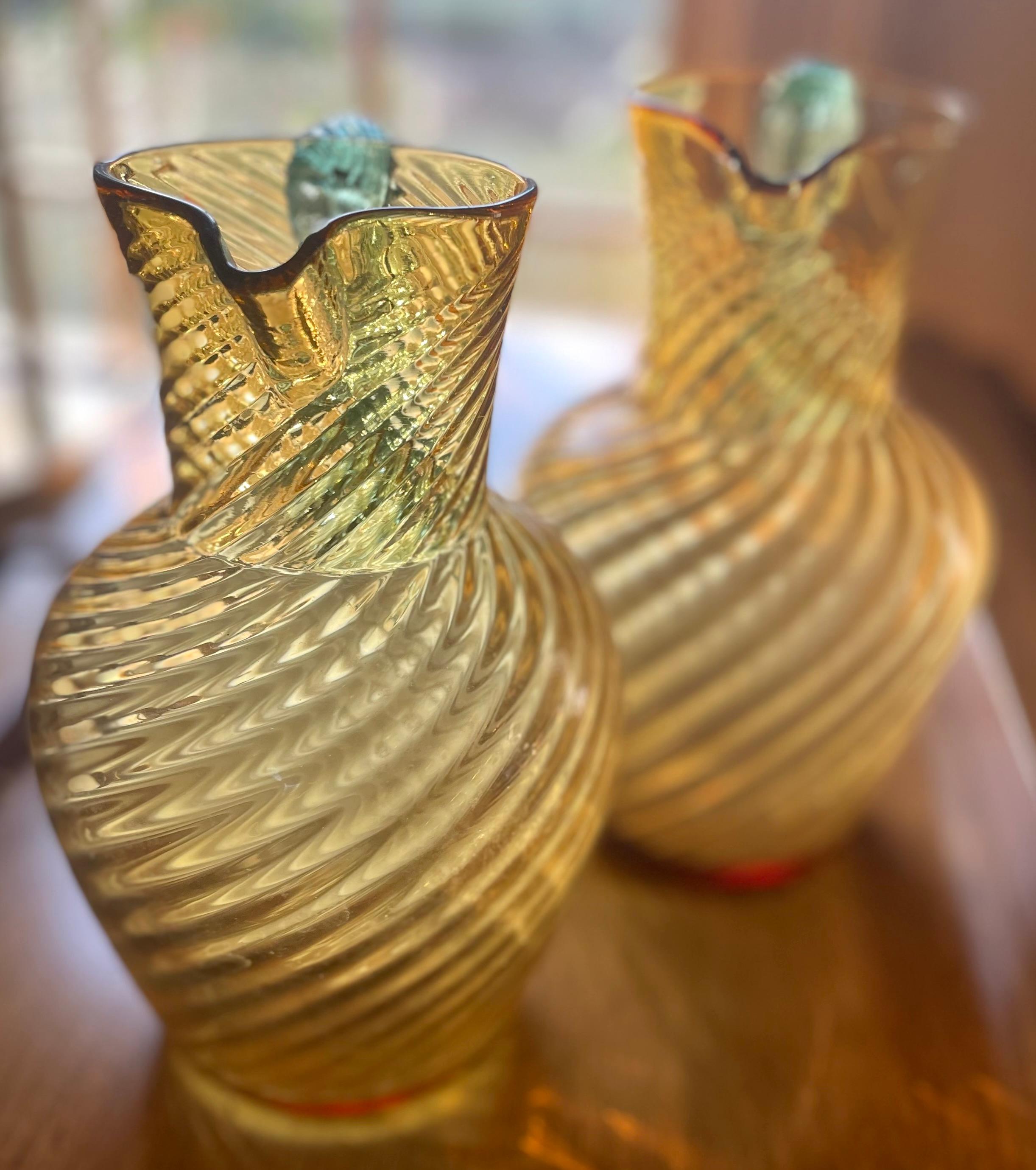 Pair Murano aquamarine and gold Pitchers. Swirled yellow gold Venetian glass with braided aquamarine handle pitchers. Italy, c. 1880's
Dimensions: 9” H x 5” diameter body; 4” diameter at base