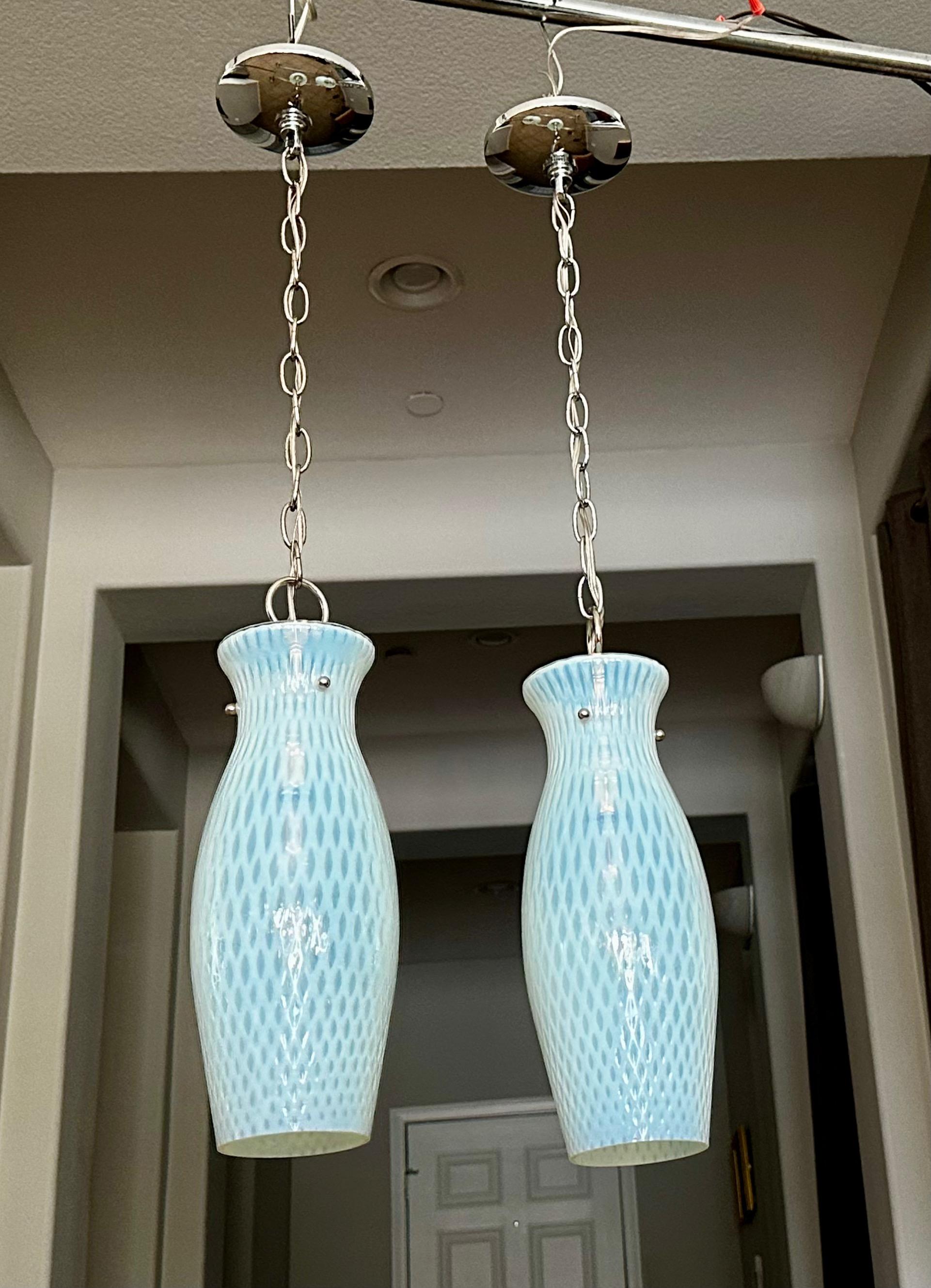 Pair Italian Murano hand blown opalescent blue glass ceiling light pendants. The opalescent glass has a diamond pattern throughout. All new nickel finish hardware including socket, chain and canopy. Uses single regular A base bulb. 
Fixture size 14