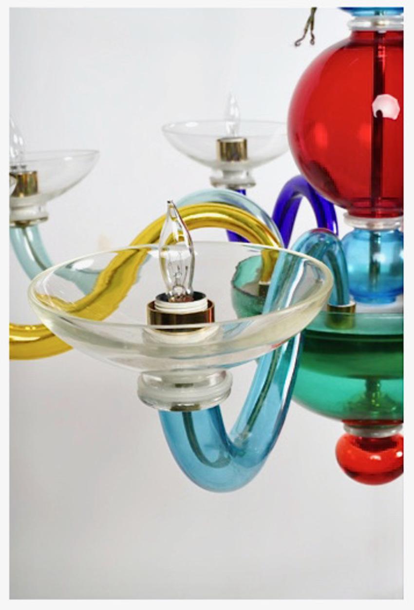 This is a stunning pair of late 20th century post modern Murano 8-light chandelier. The choice of colors and form were inspired by the Memphis design movement of the 1980s. Both chandeliers are in good to very good condition with a couple of very