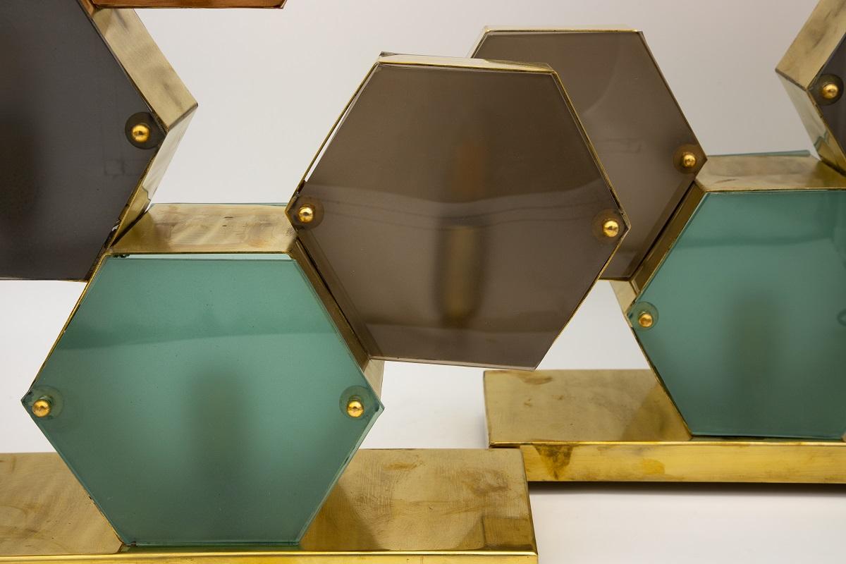 A pair of murano glass lamps. Stacked brass hexagons in graduated depths with glass colors in aqua, taupe, gray, and peach on both sides of the hexagon. Beautiful from every angle. Each shape has its own bulb. Decorative screws remove for easy bulb